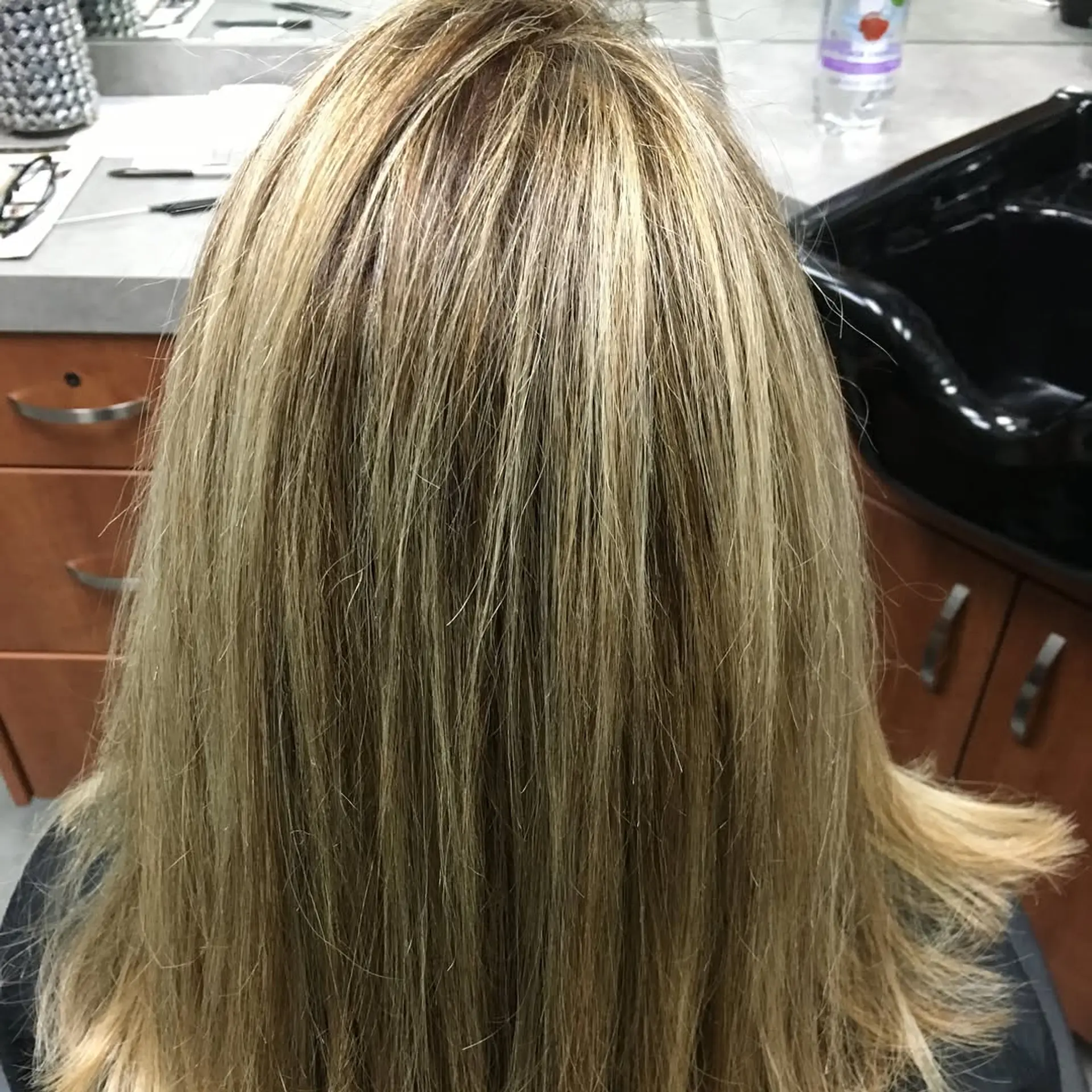 Medium-length straight hair styled smooth with fine, multi-dimensional blonde highlights blended over a natural light brown base. 1