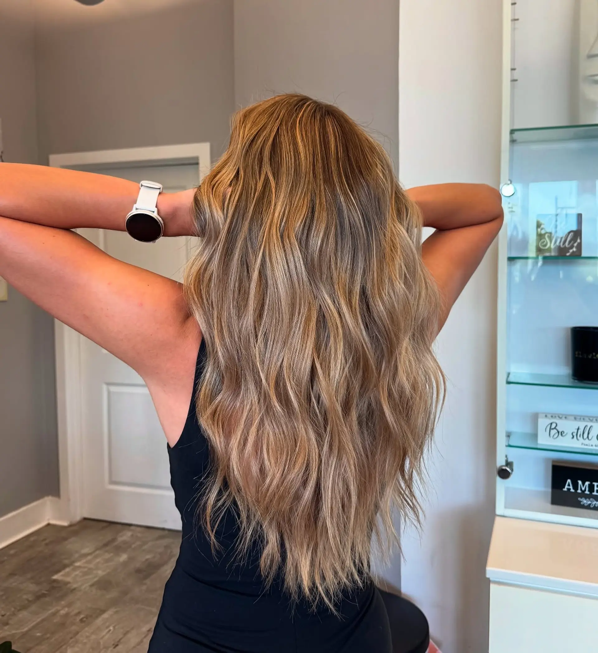 Long, wavy hair with a golden blonde balayage. 2