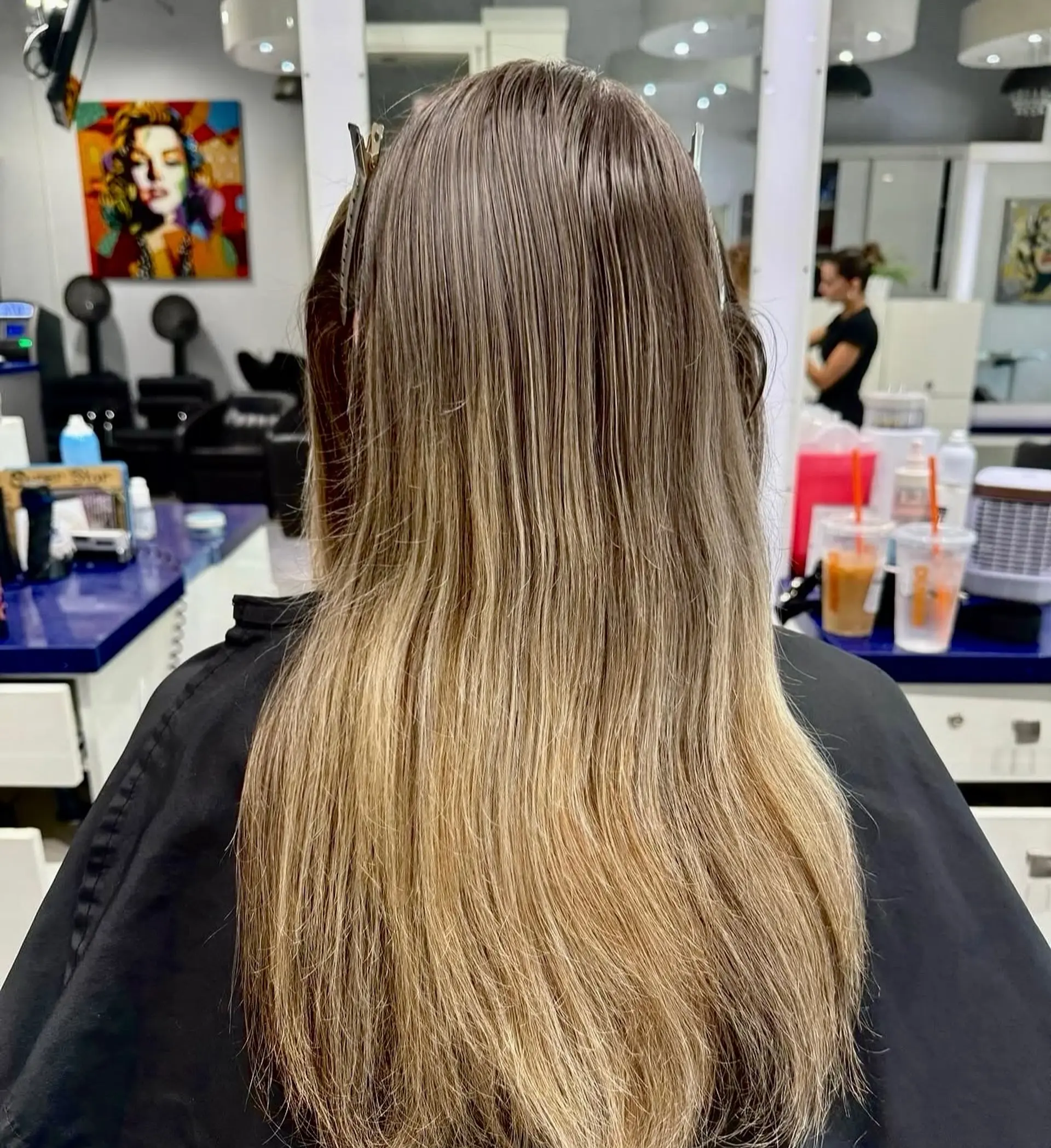 Long, wavy hair with a golden blonde balayage. 3