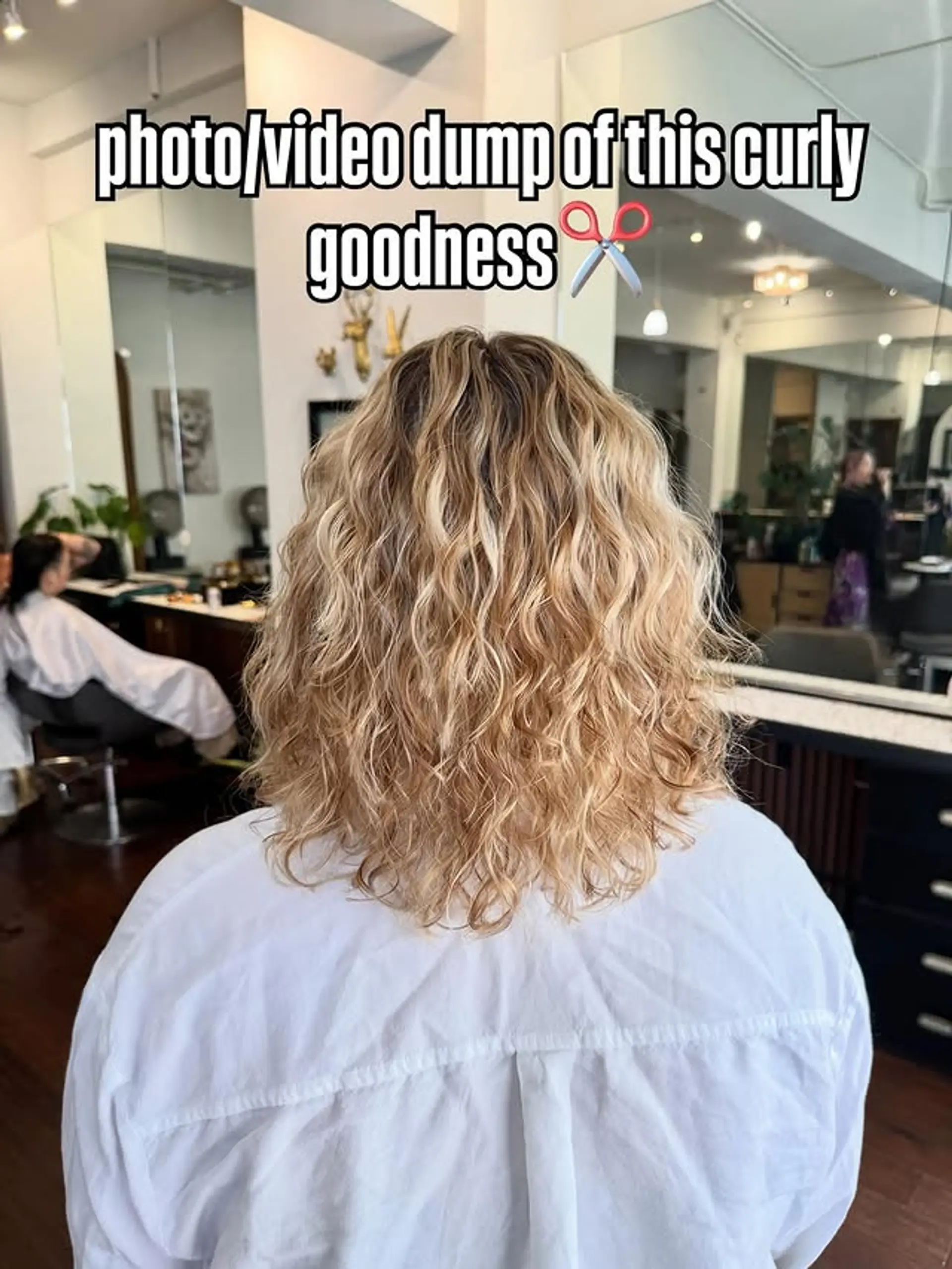 A medium-length curly lob (long bob) with bronde dimensional coloring. 1