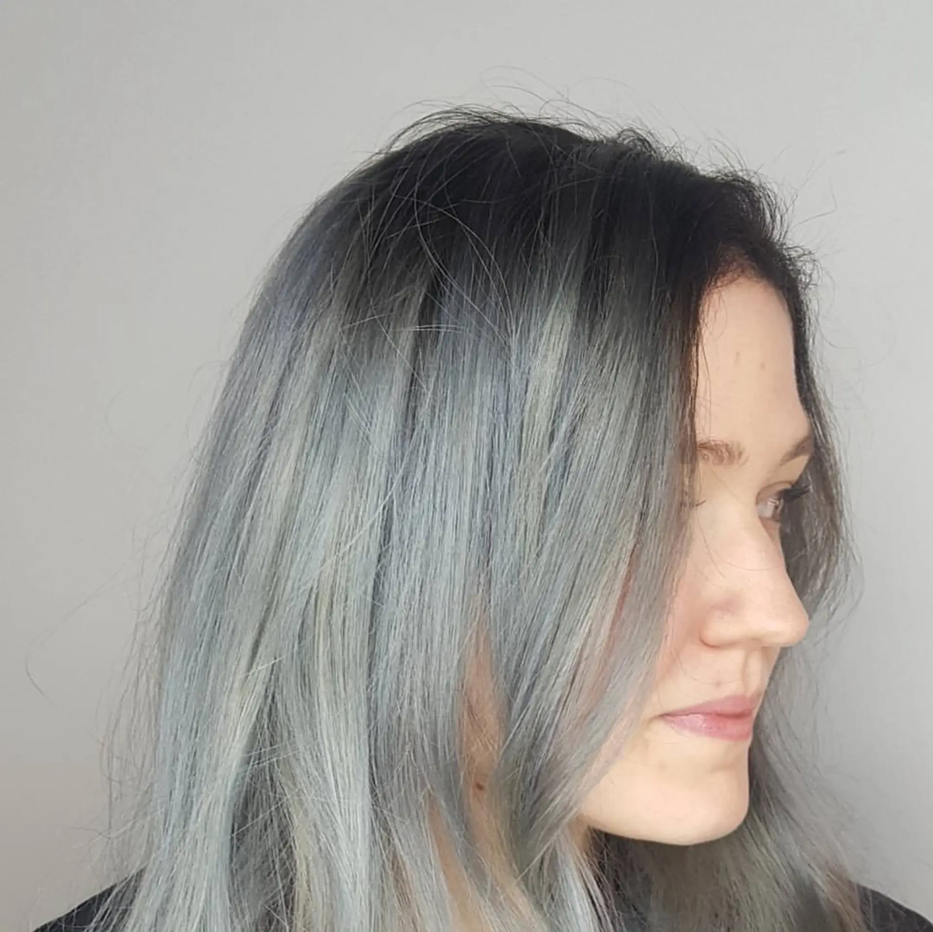 Medium-length straight hair featuring a cool smoky silver-grey tone with dark shadow roots. 1