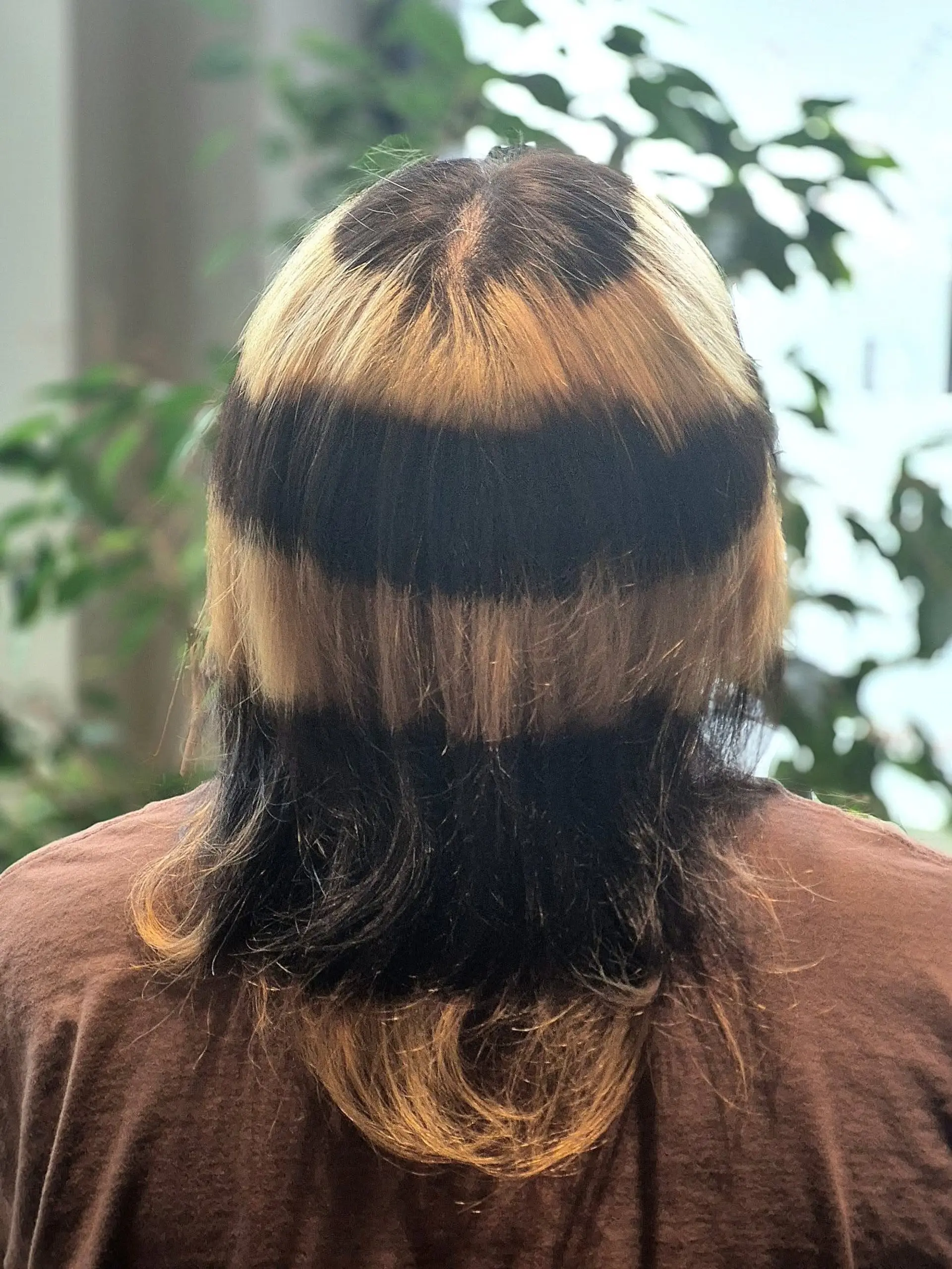 A medium-length hairstyle featuring dramatic alternating horizontal bands of warm blonde and deep black. 1