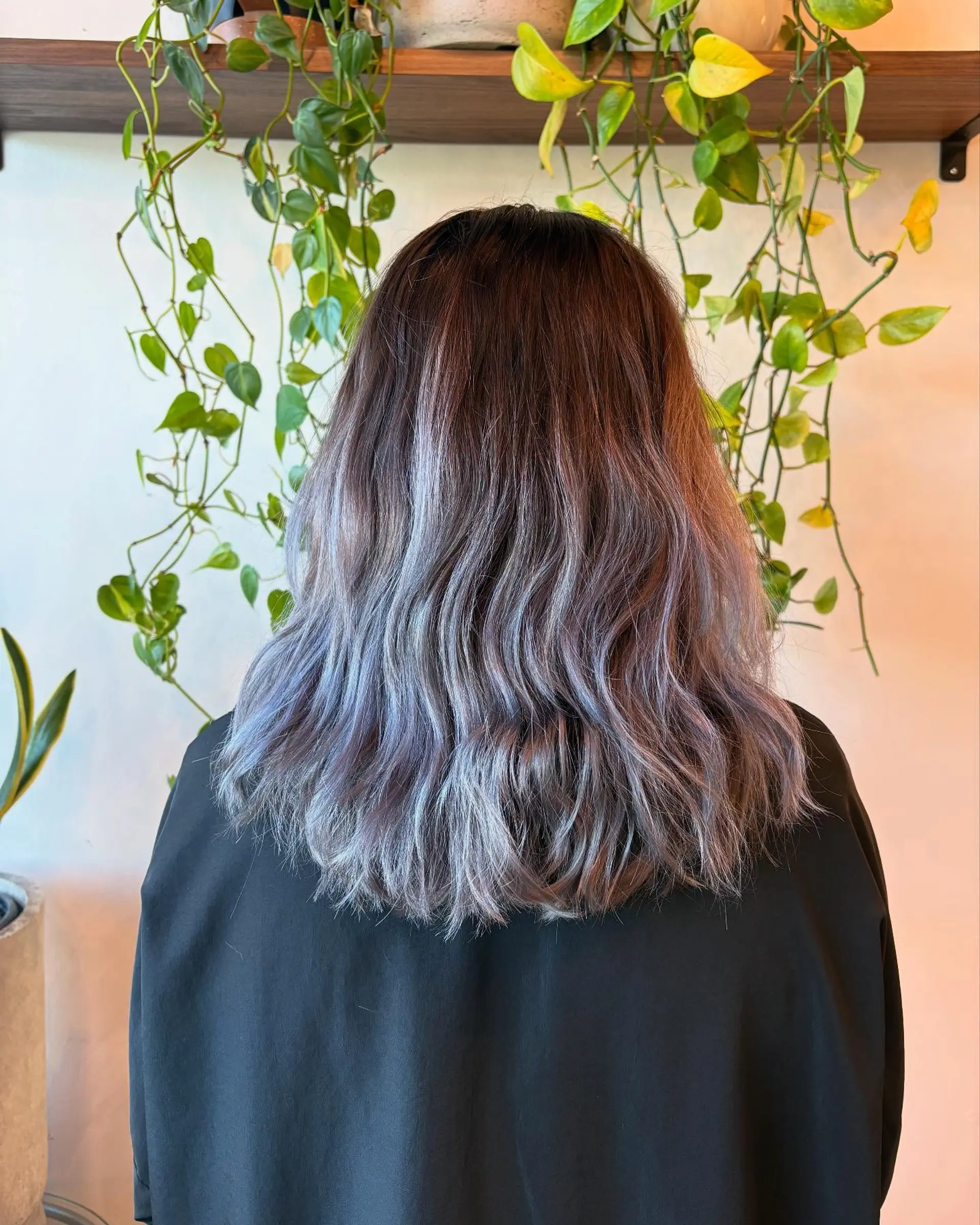 Medium-length dark brown hair fading into a smoky silver and pearl ombré styled in soft waves. 1