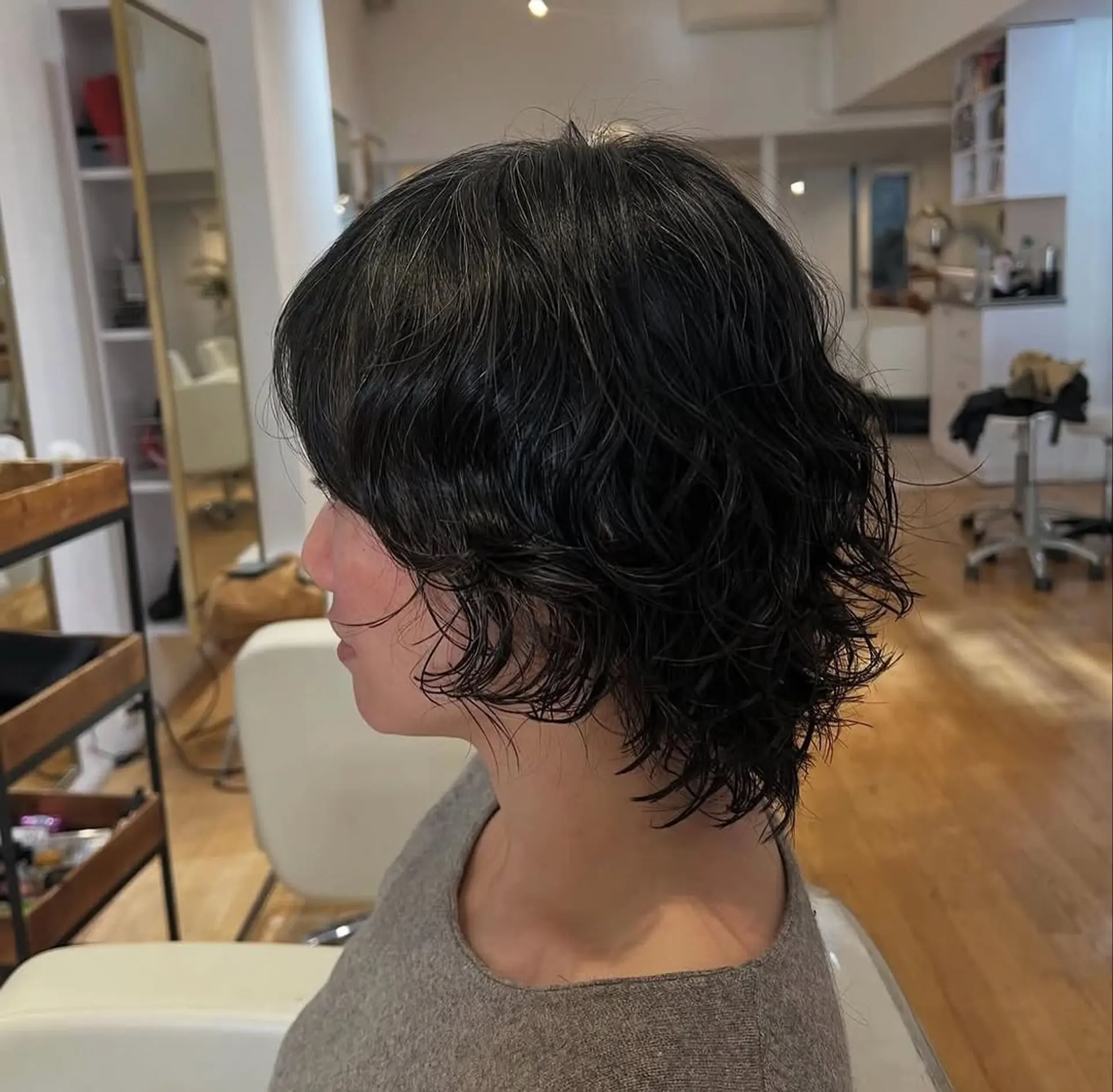 A shaggy, wavy bob with choppy layers and full bangs. 1
