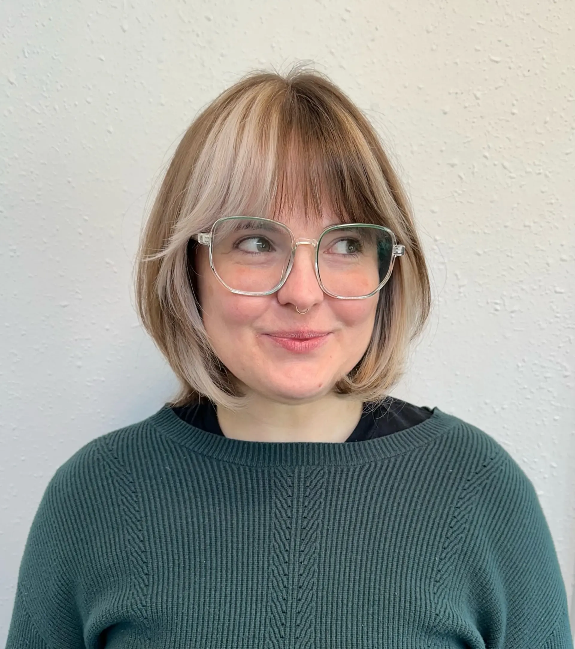 A textured chin-length Italian bob featuring wispy fringe bangs and striking color blocking in the front. 1