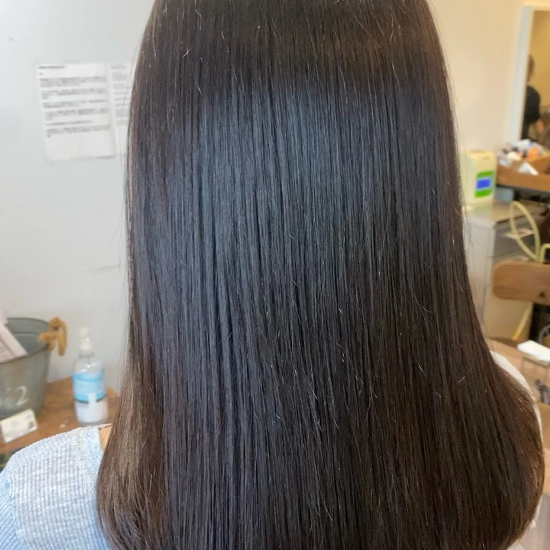 Ultra-sleek, glossy pin-straight hair achieved with Japanese thermal reconditioning. 1