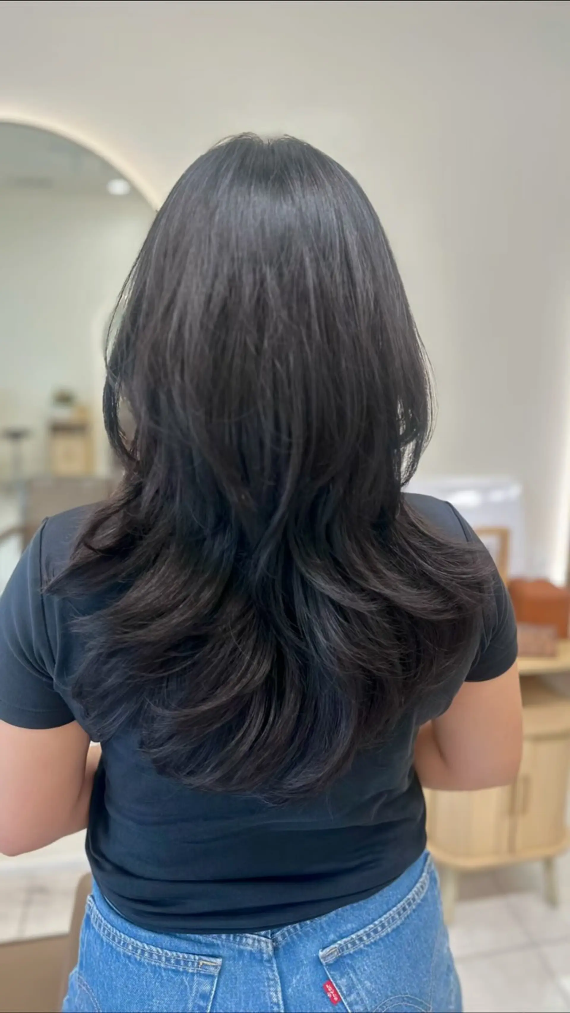 A medium-to-long Korean hush cut featuring multi-tiered, lightweight layers and softly curved ends that provide airy volume and movement. 1