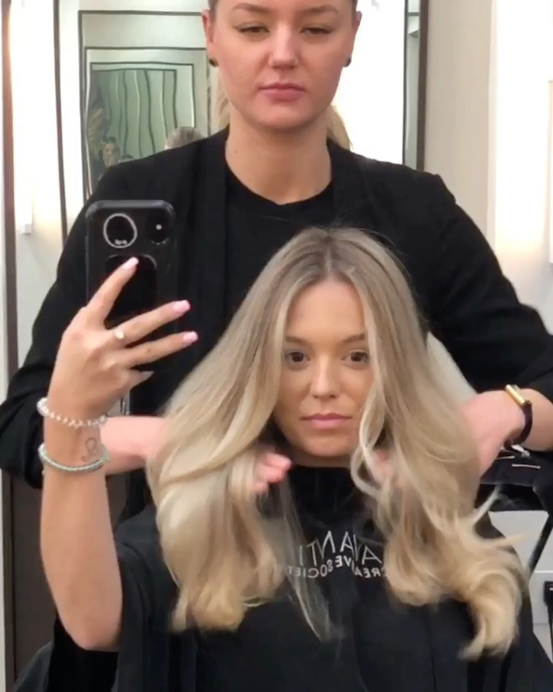 A seamless, dimensional blonde balayage styled with voluminous blowout waves and a center part. 1