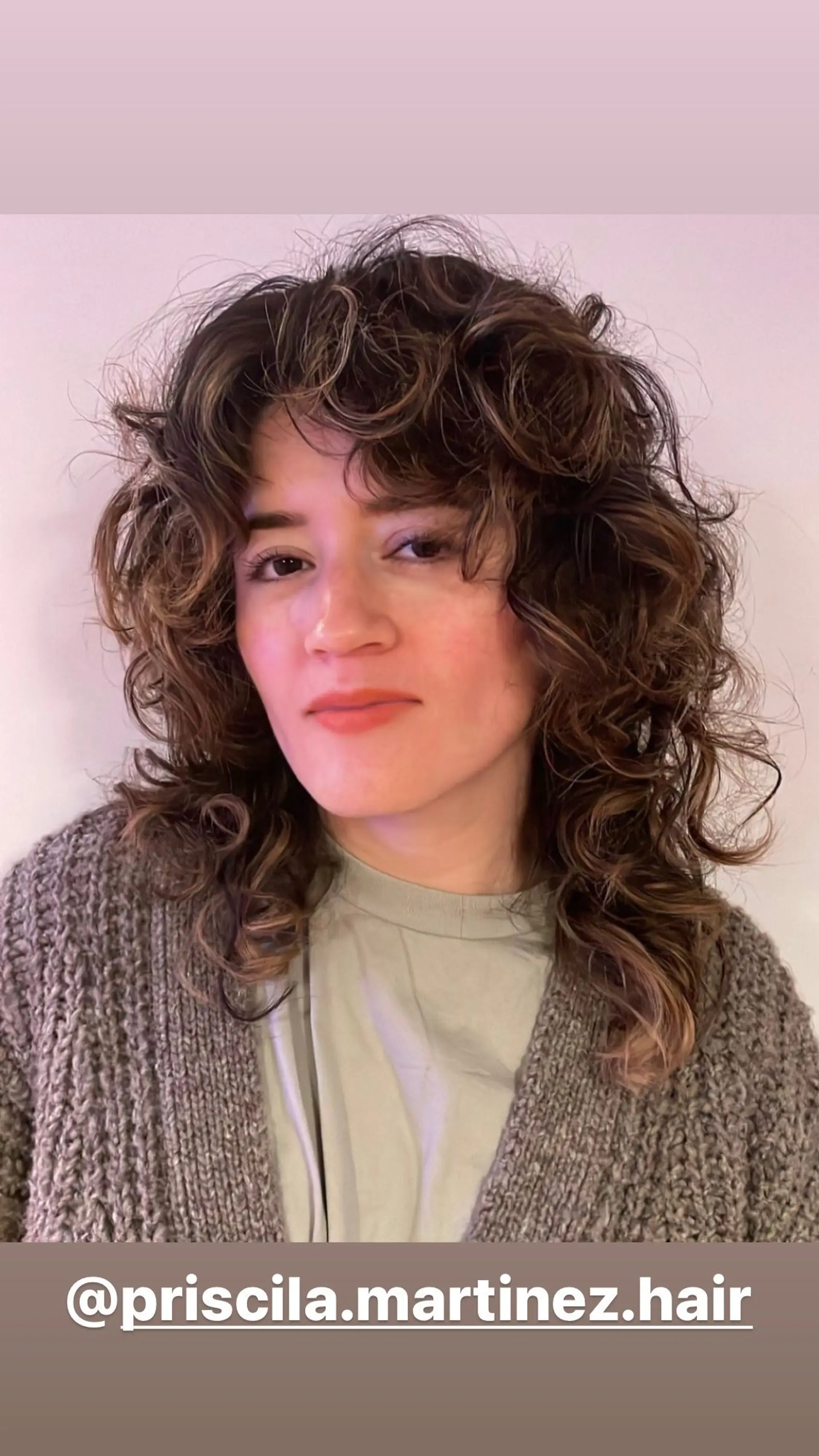 A shaggy, layered mullet with bouncy curls and face-framing bangs. 1