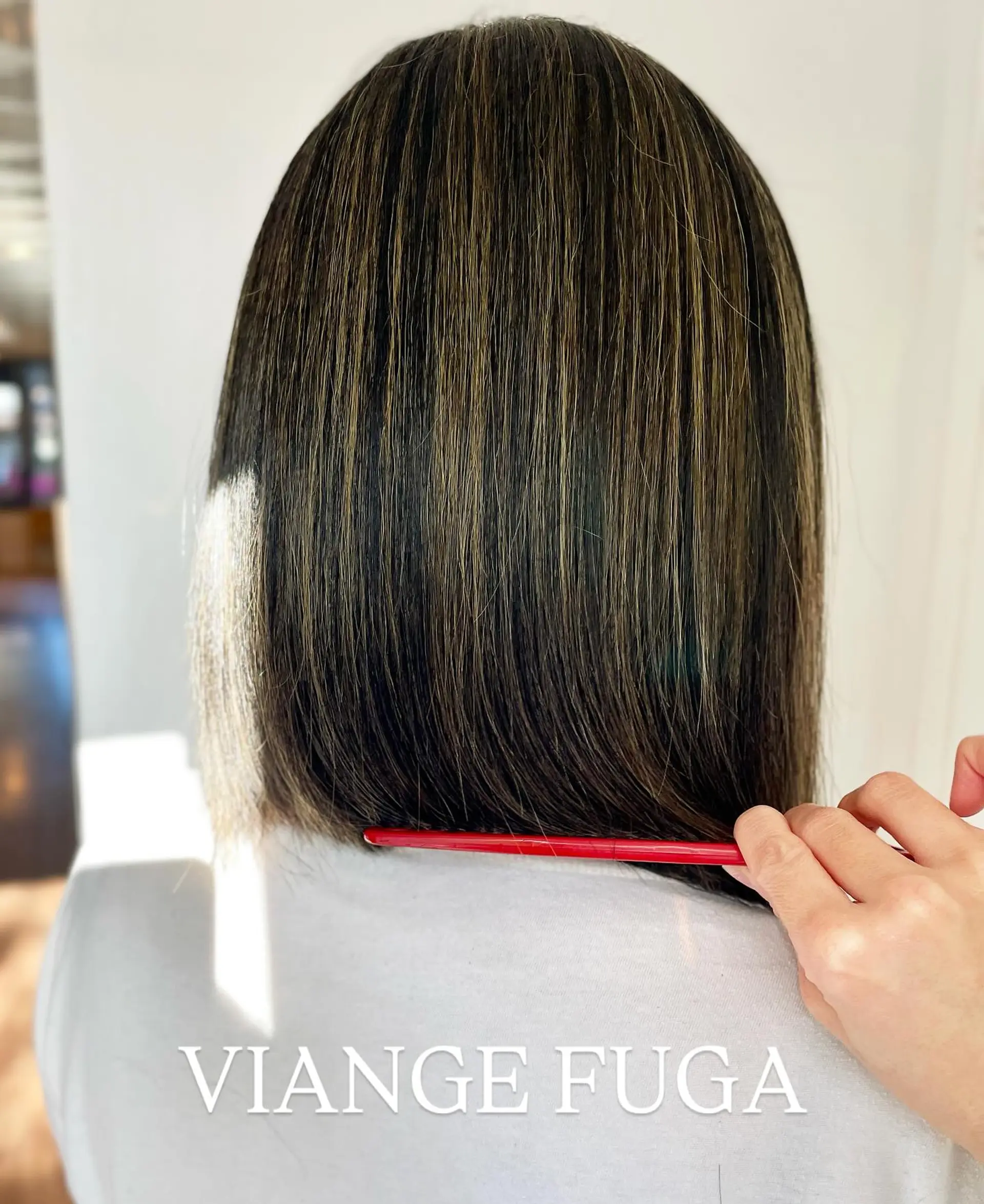 A sleek, precision blunt bob cut resting right at the nape with delicate highlights for subtle dimension. 1