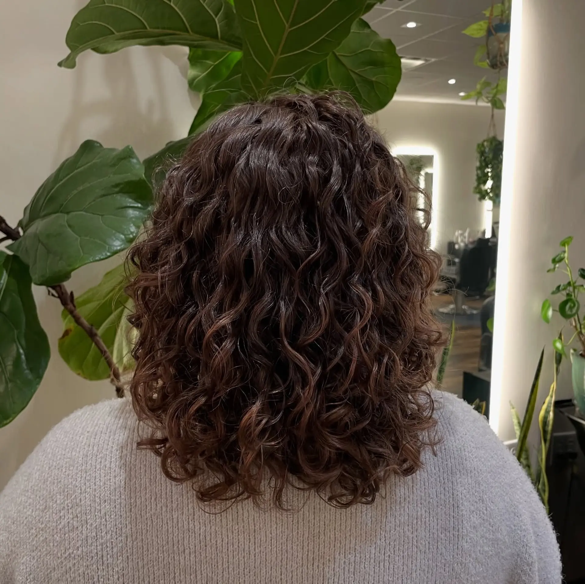 Shoulder-length cut with defined, bouncy curls and light shaping layers. 1