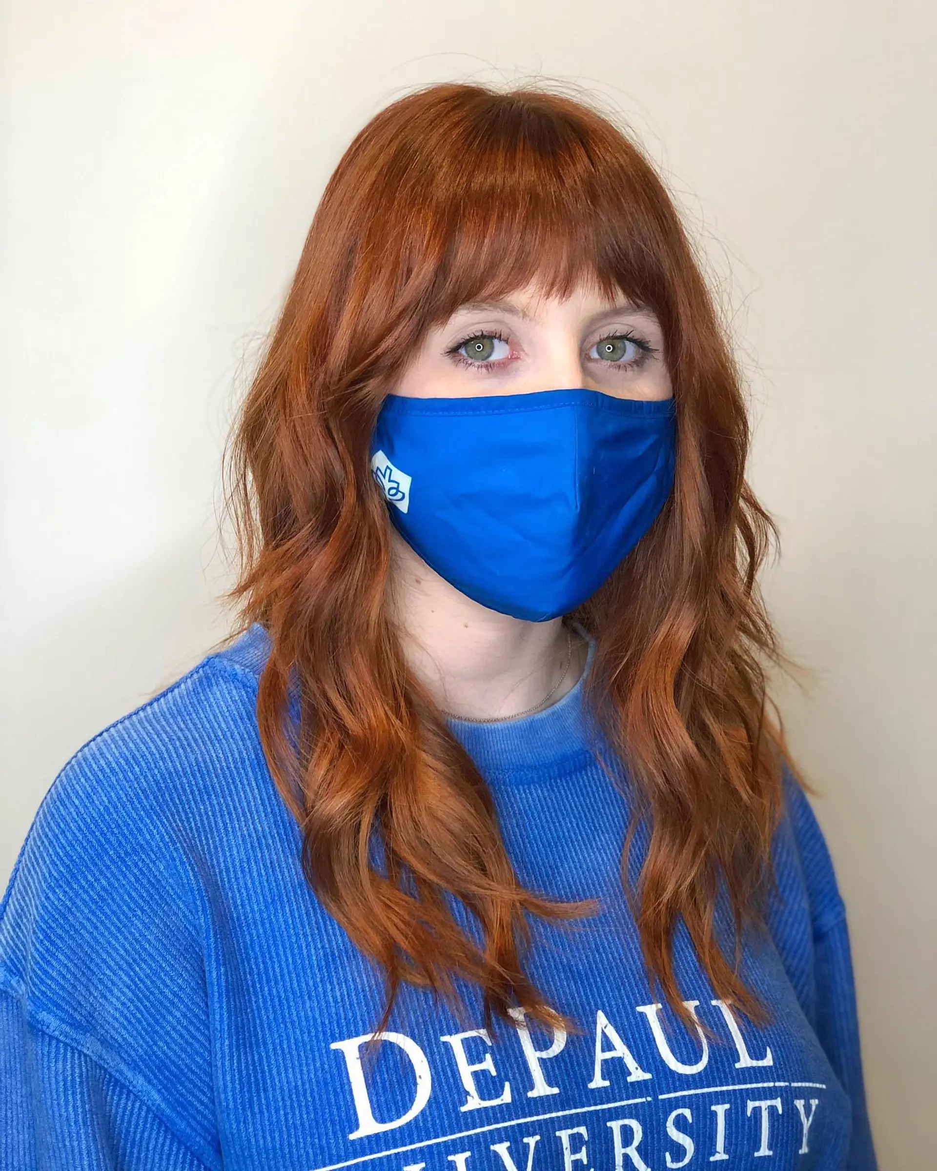 A medium-length shag haircut with face-framing layers and wispy bangs. 1