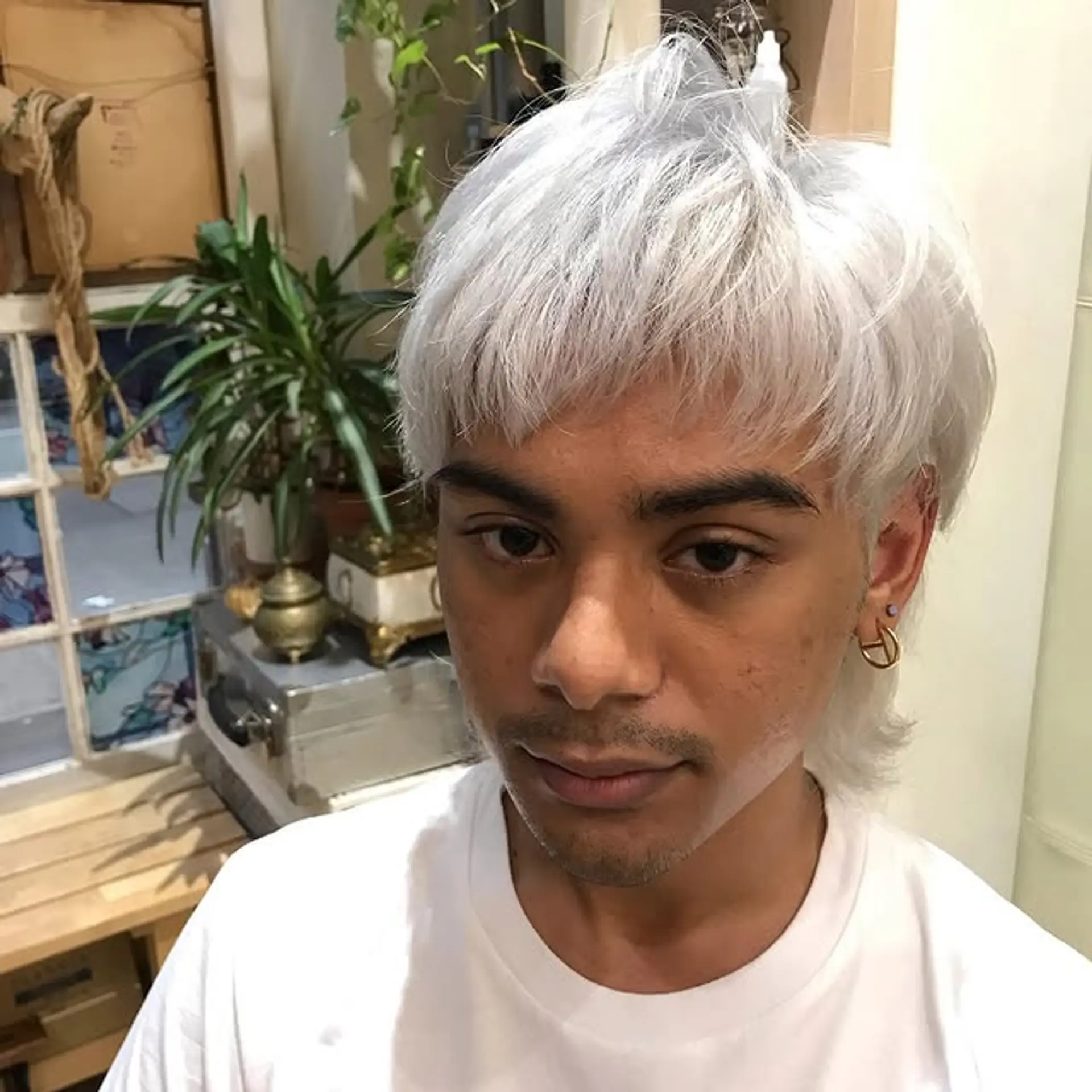 A modern take on the classic mullet, featuring shorter layers on top and longer lengths in the back. Styled in a vibrant platinum/silver. 1