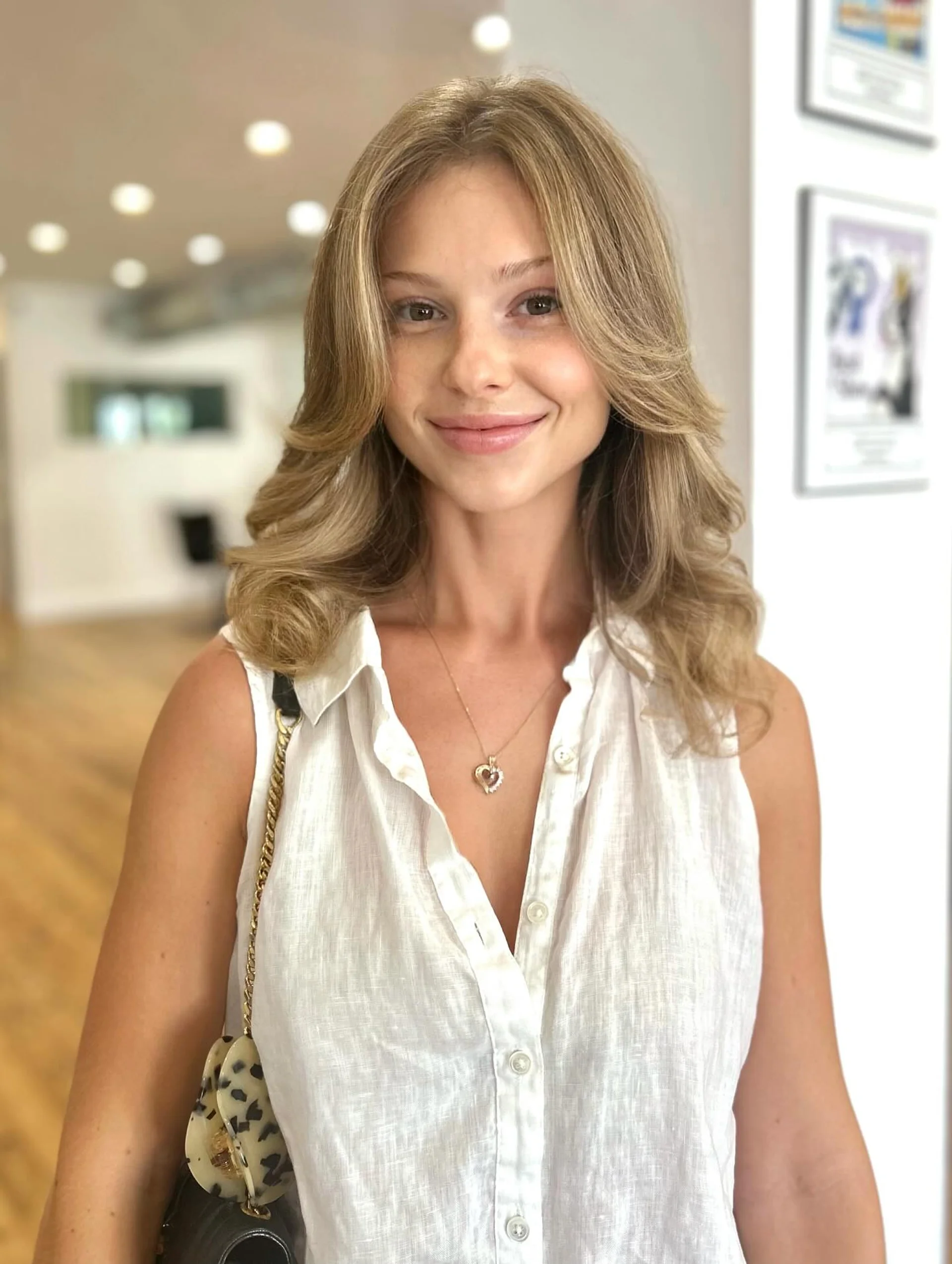 Voluminous 90s layered blowout with soft waves and curtain bangs - Preview 1