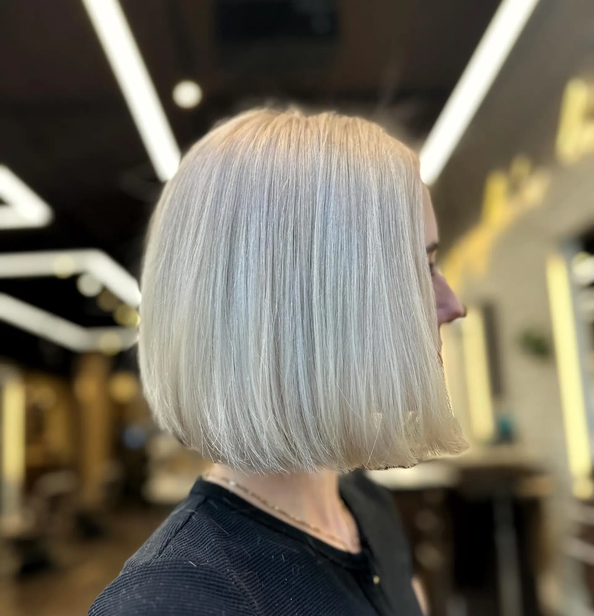 A sleek, chin-length bob with a modern platinum blonde color. 1