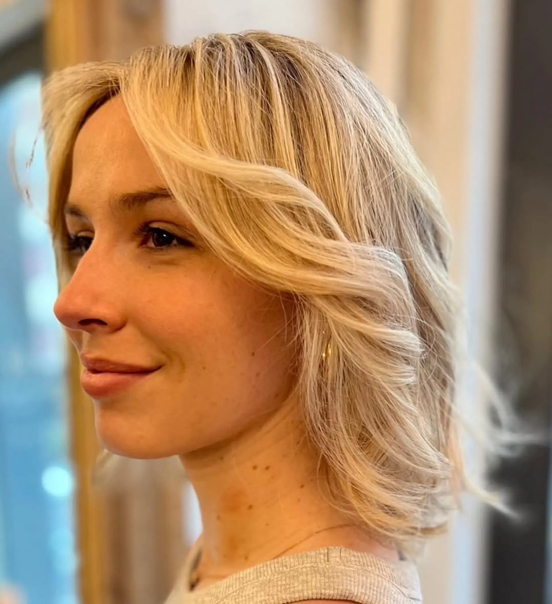 Medium-length wavy blonde hair with a layered cut, featuring soft waves and a side part with subtle highlights.

Color by Kaori. Cut by Taka. Style by Hazuki 3
