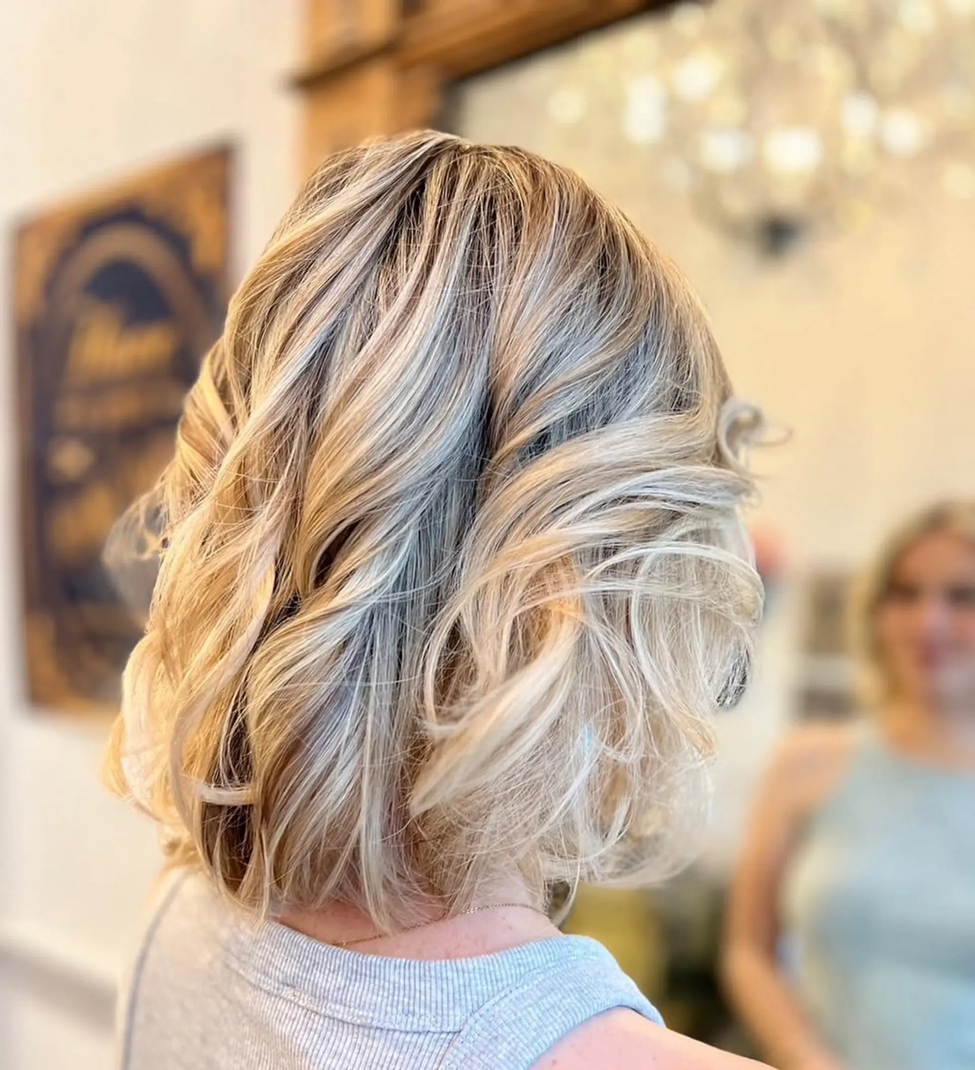 Medium-length wavy blonde hair with a layered cut, featuring soft waves and a side part with subtle highlights.

Color by Kaori. Cut by Taka. Style by Hazuki 2