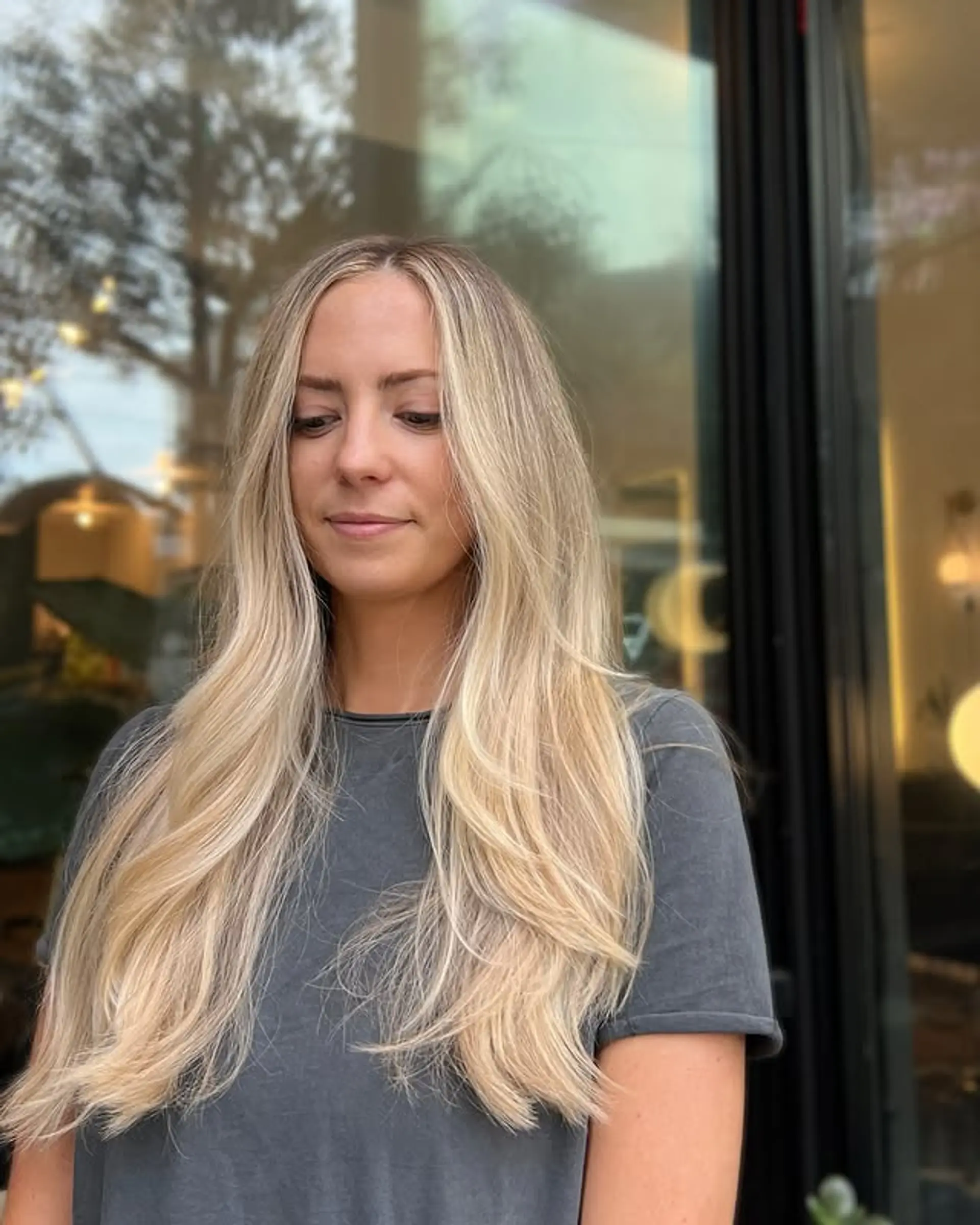 Long layered haircut with a cream blonde balayage and money piece. 1