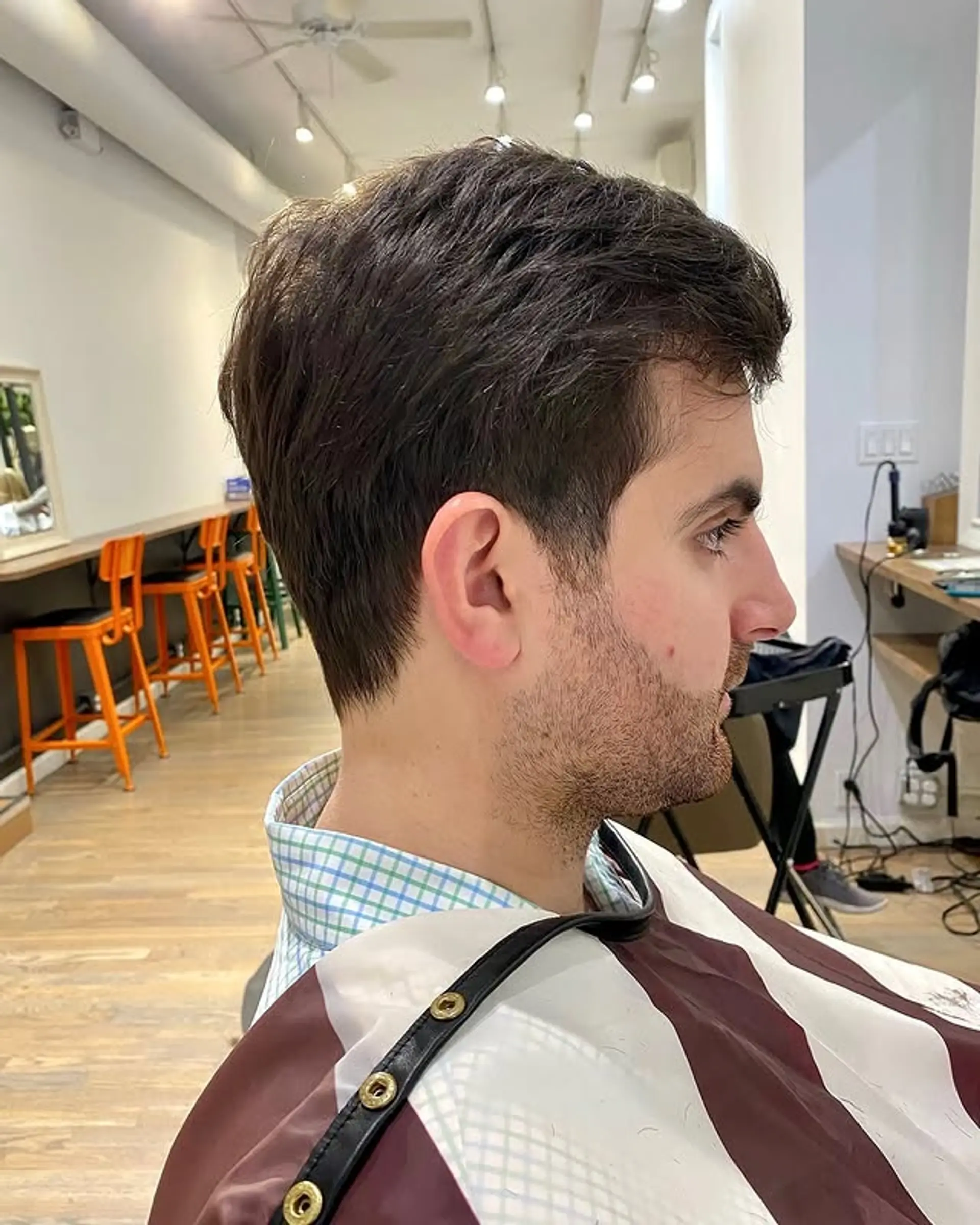 A classic short haircut with tapered sides and a textured top. 1