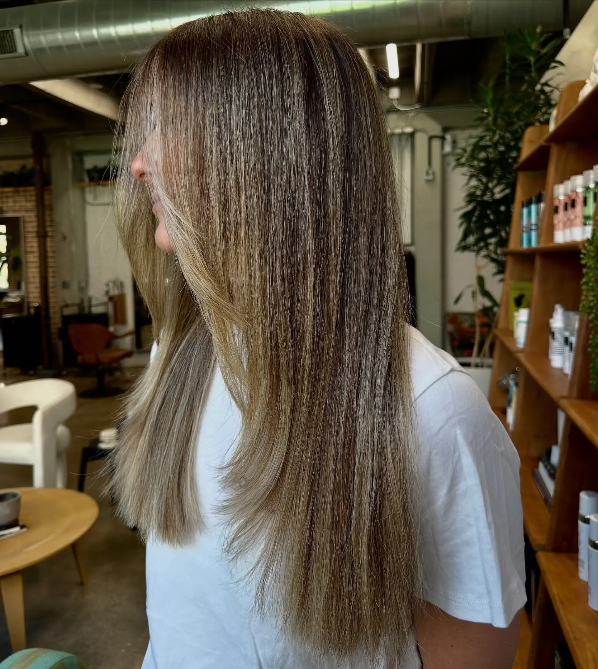 Long, straight hair with subtle layers and a bronde balayage. 1