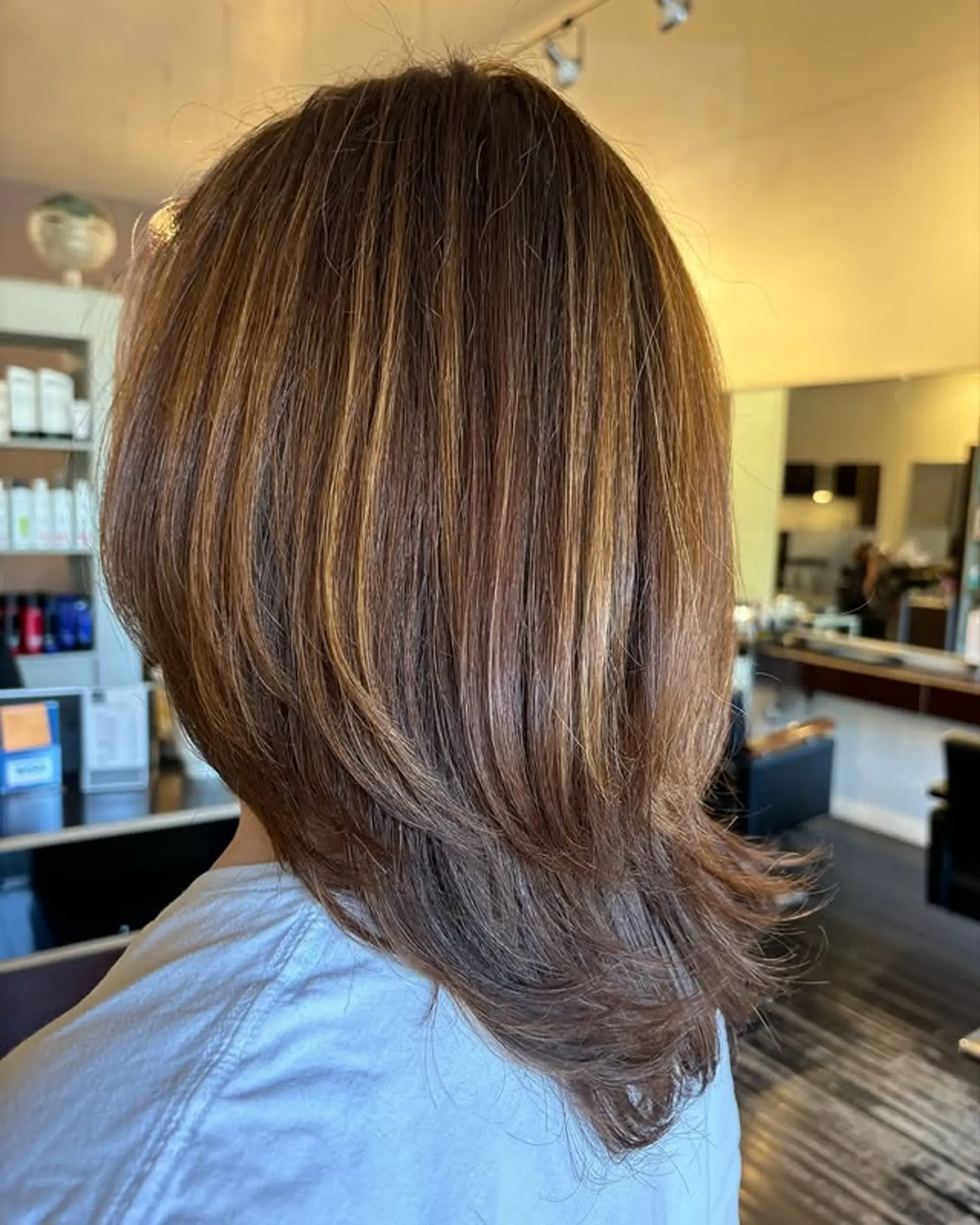 Layered medium length hair with brown and blonde balayage highlights. 1
