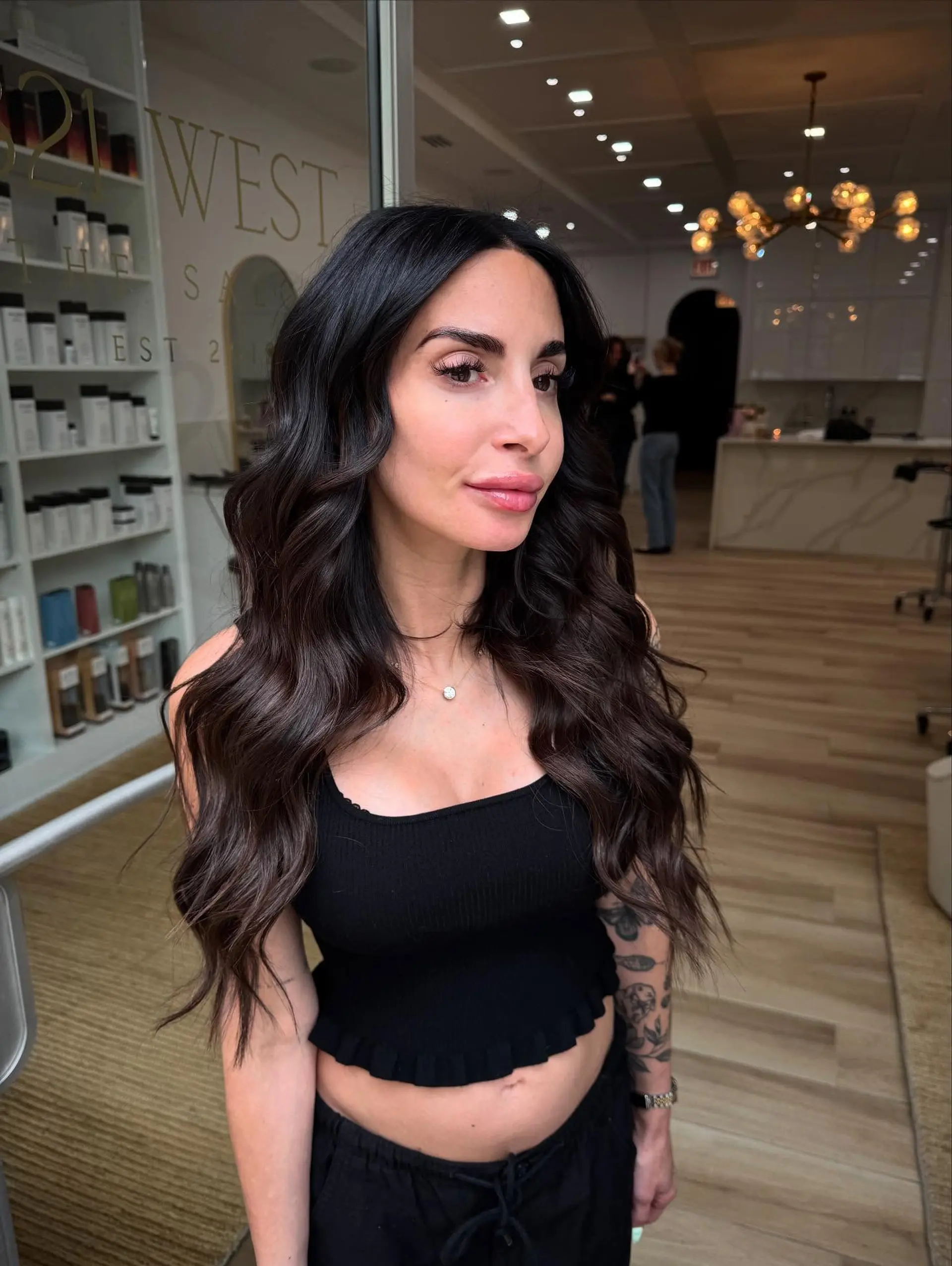 Long, rich dark chocolate brunette hair styled in soft, cascading waves with a center part. 1