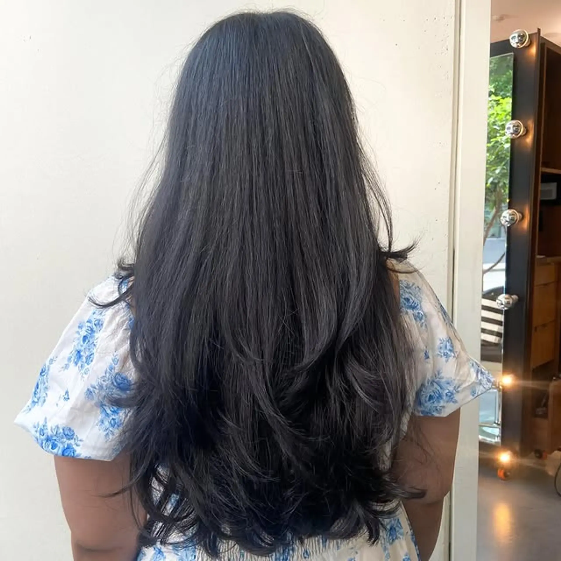 A long hairstyle with prominent V-cut layers, creating a soft, cascading effect. 1