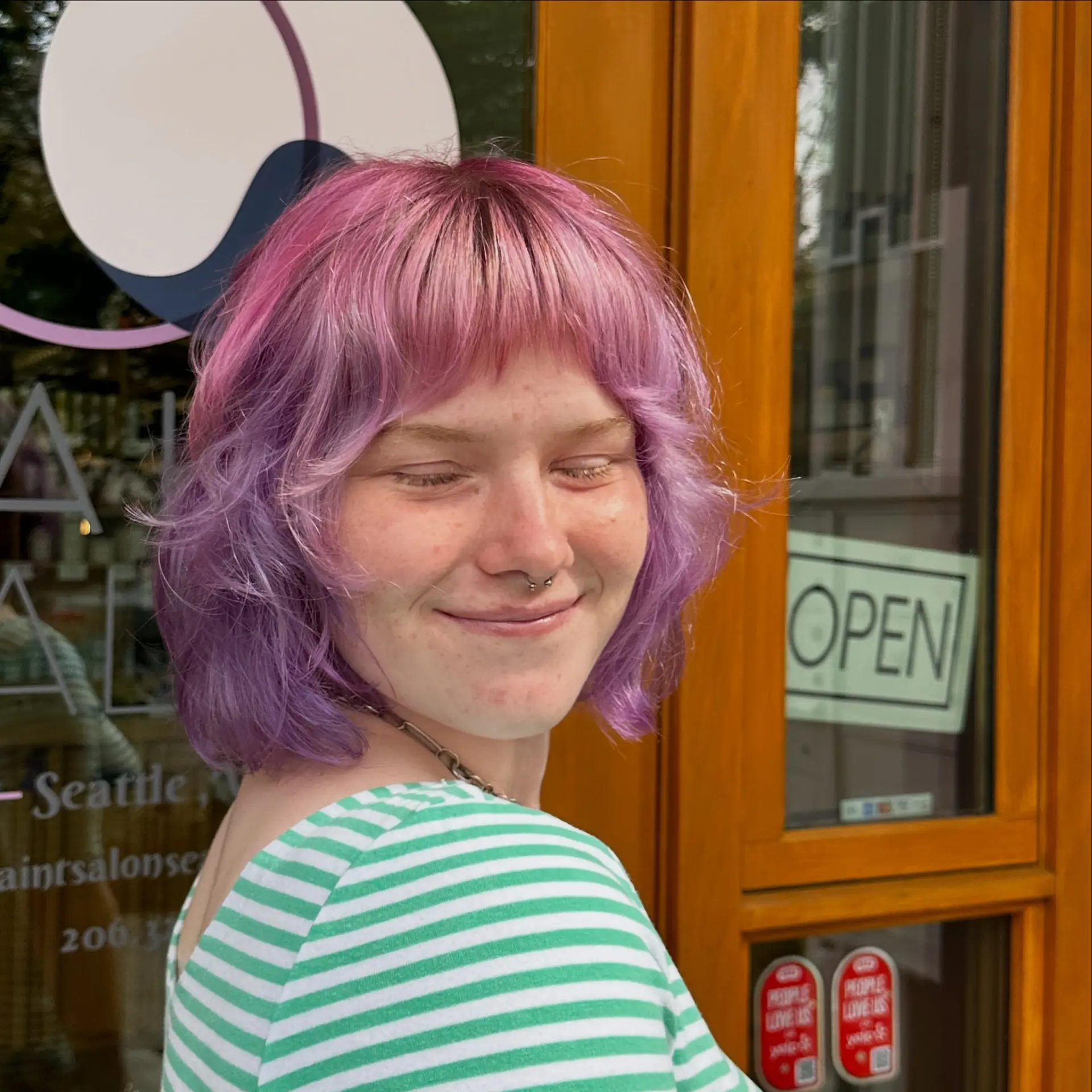 A textured chin-length shaggy bob featuring soft, flipped-out wavy layers, choppy micro fringe, and a dimensional color melt from bright pink roots into soft lavender tones. 1