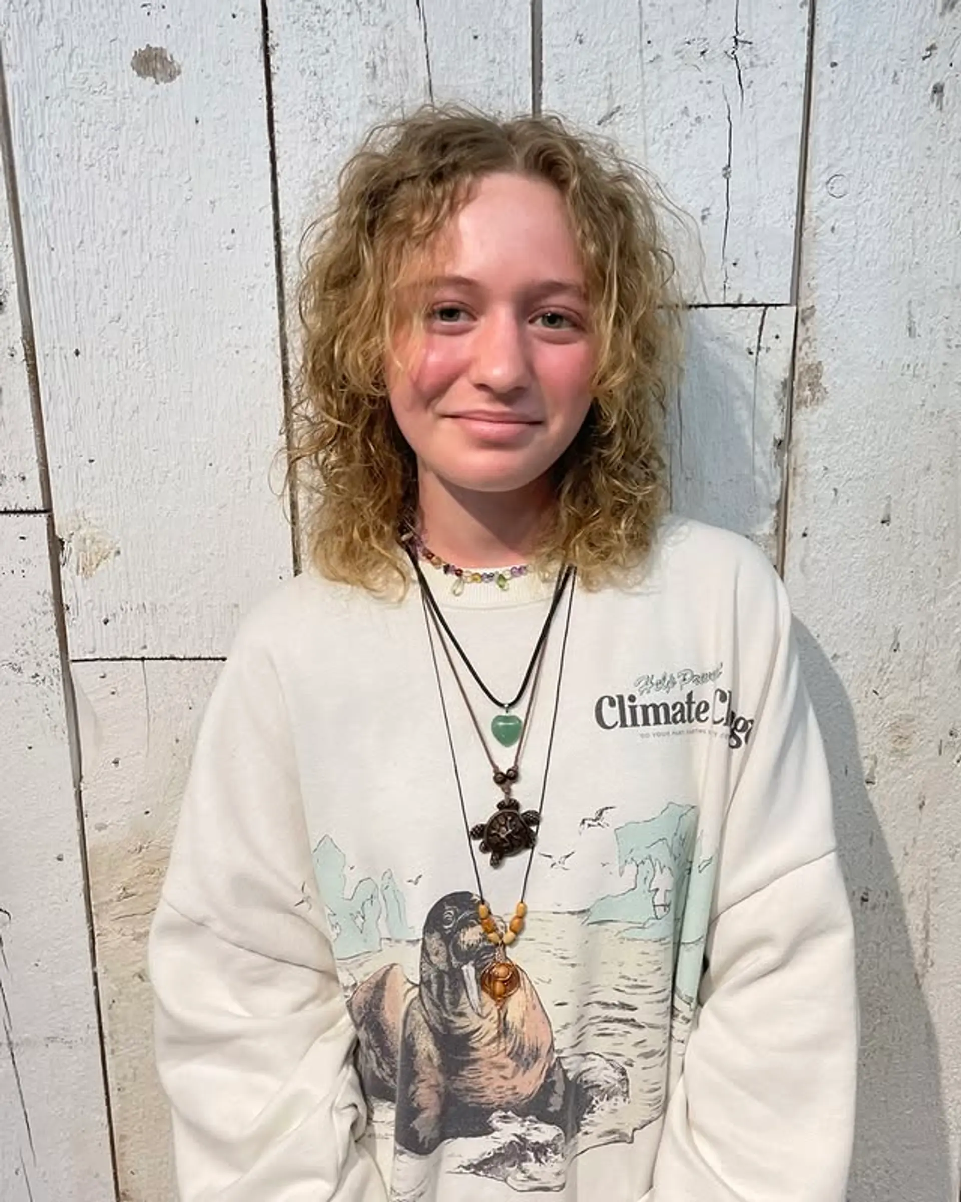 A modern shag haircut with textured layers designed to enhance natural curls. 1