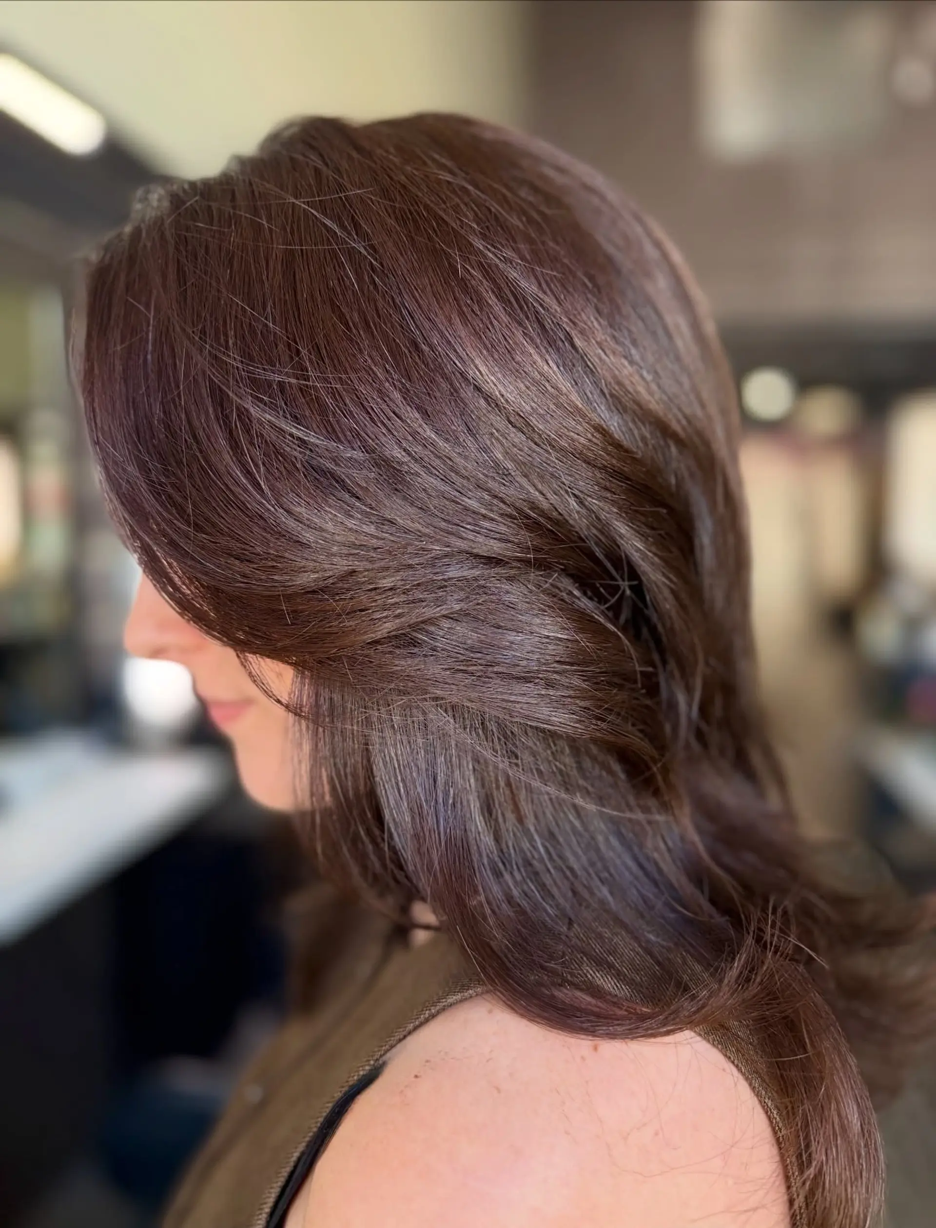 Medium-length rich brunette hair cut with soft, sweeping face-framing layers and a feathered finish. 1