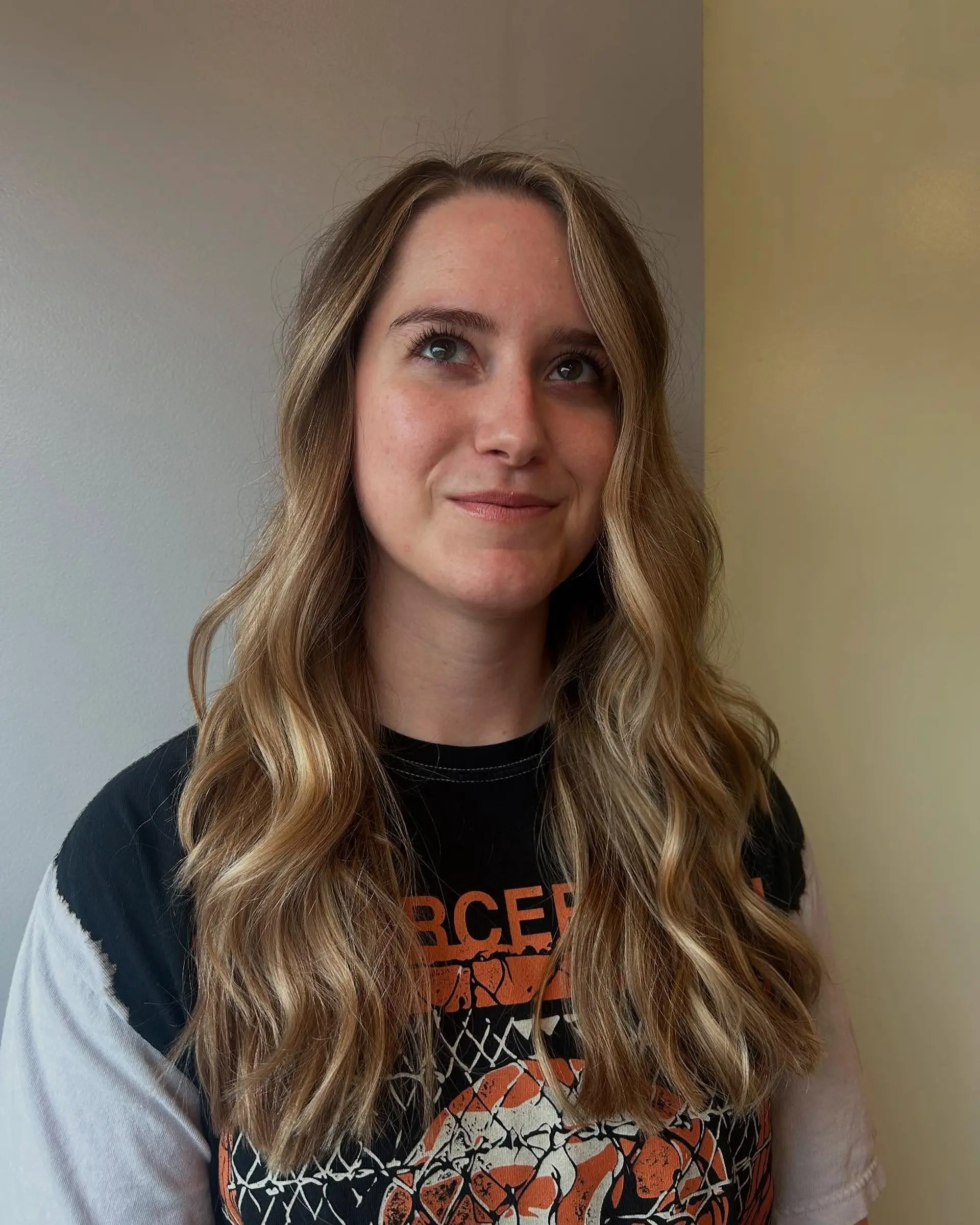 Long layered hair styled with loose, beachy waves and dimensional blonde balayage with face-framing highlights. 1