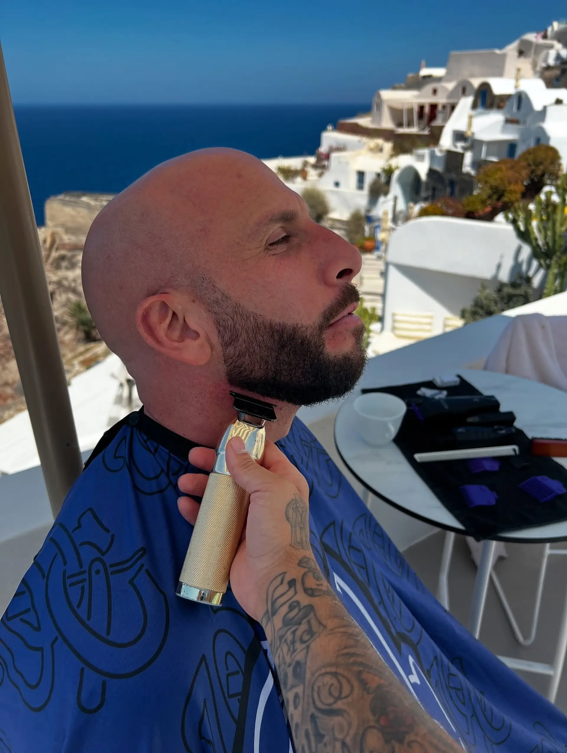 A smooth, cleanly shaved bald head paired with a sharply defined, groomed full beard. 1