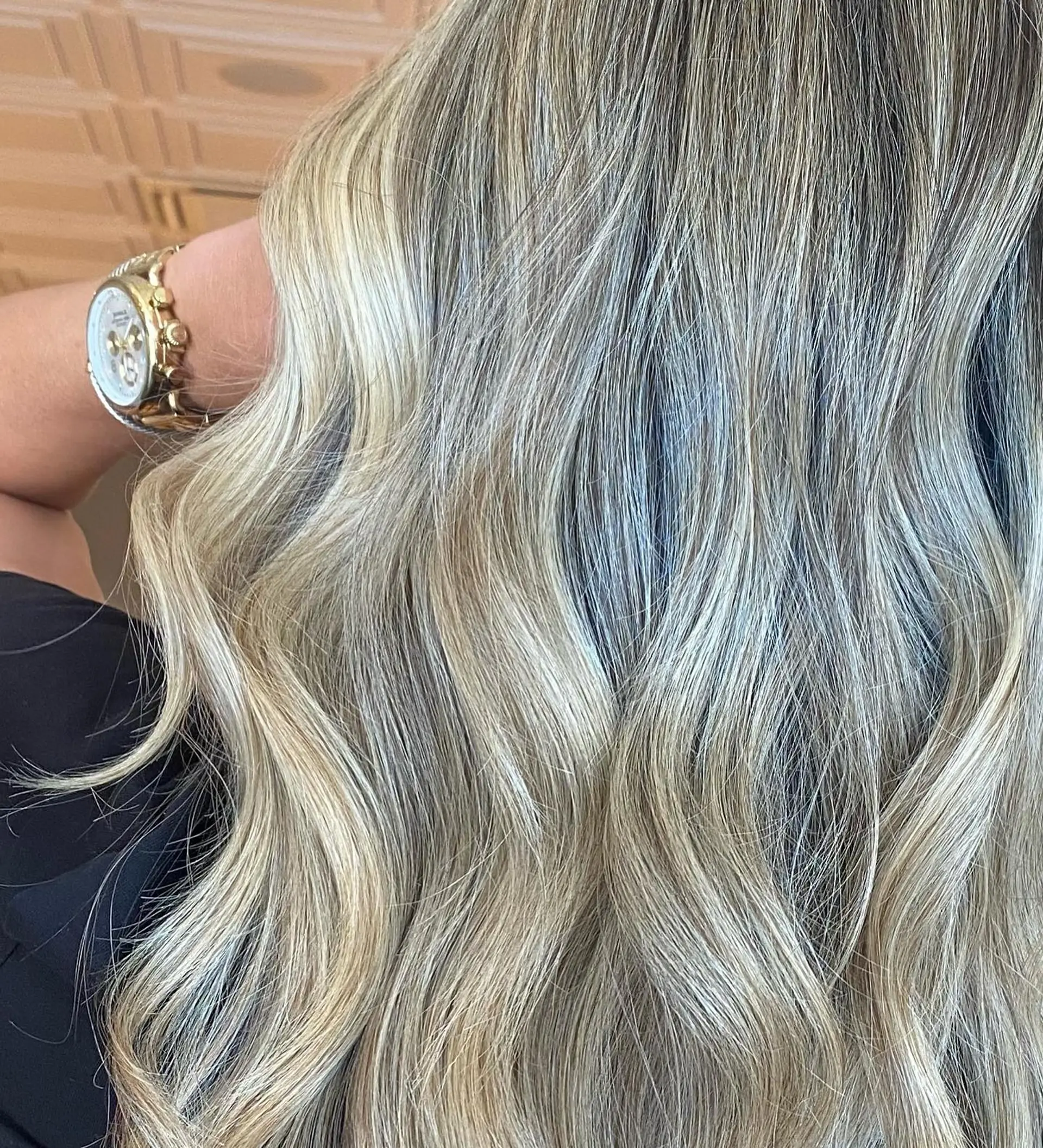 Dimensional cool ash blonde balayage highlights styled in soft, loose waves. 1