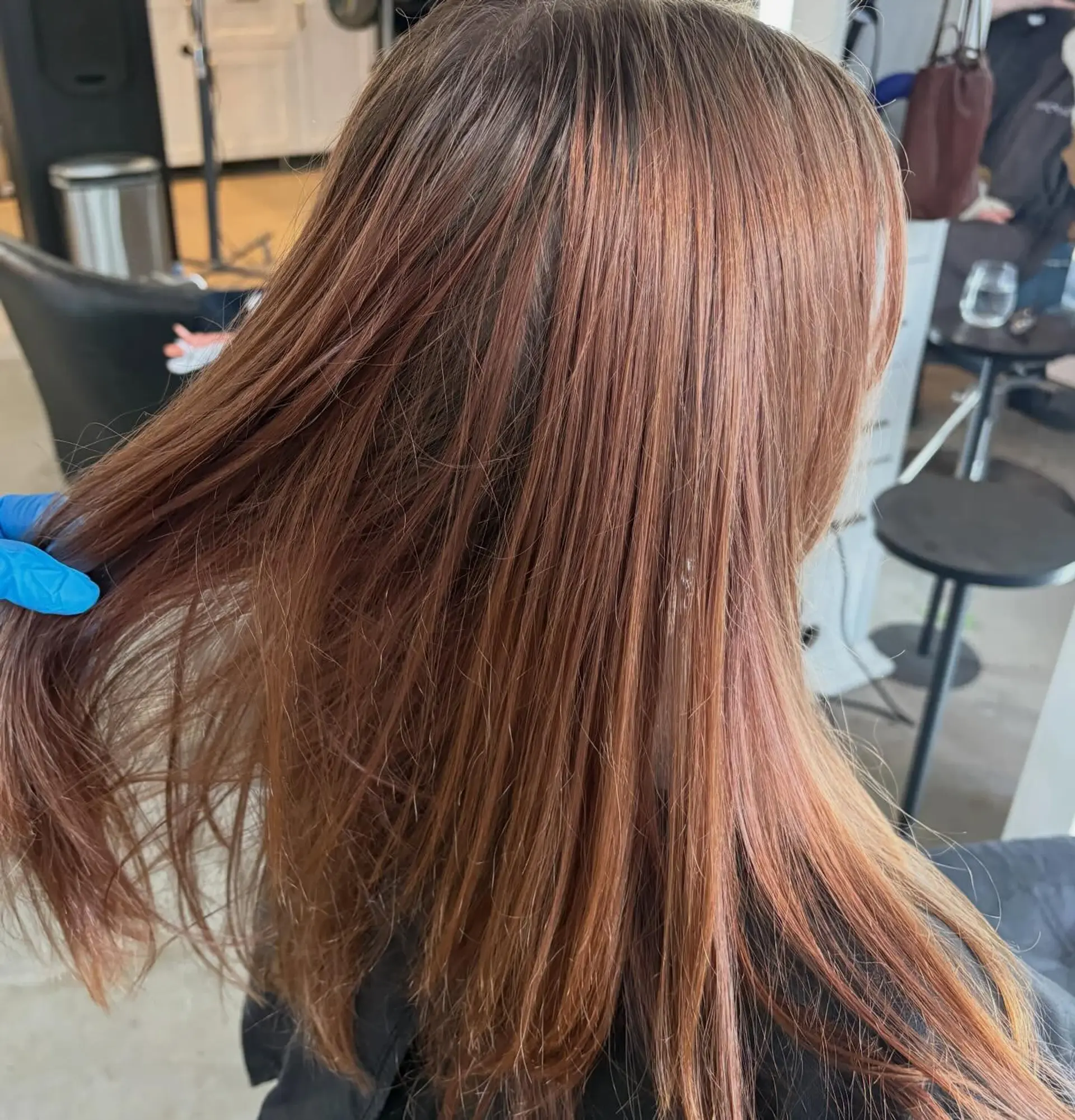 Long straight hair dyed in a dimensional copper-red and auburn tone, styled sleek and smooth. 1