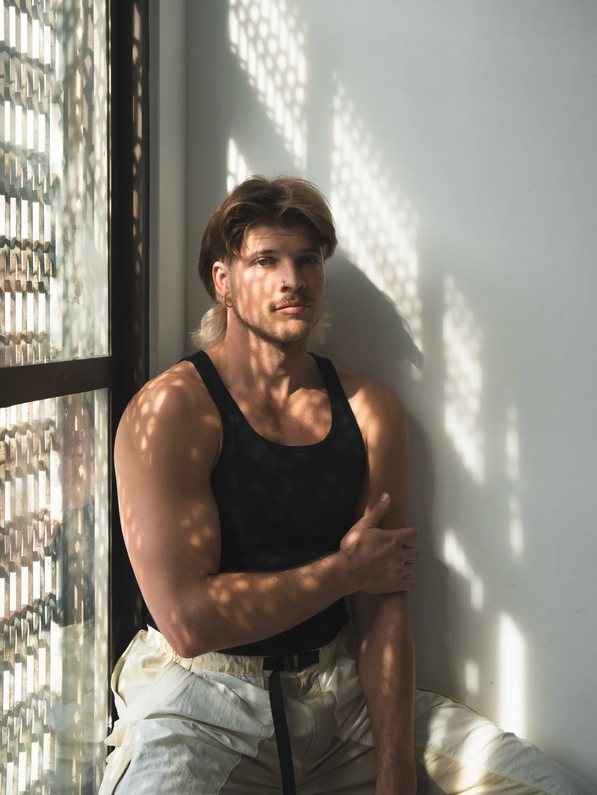 A retro-inspired modern mullet featuring layered light brown hair on top and a contrasting bleached blonde tail at the nape. 1