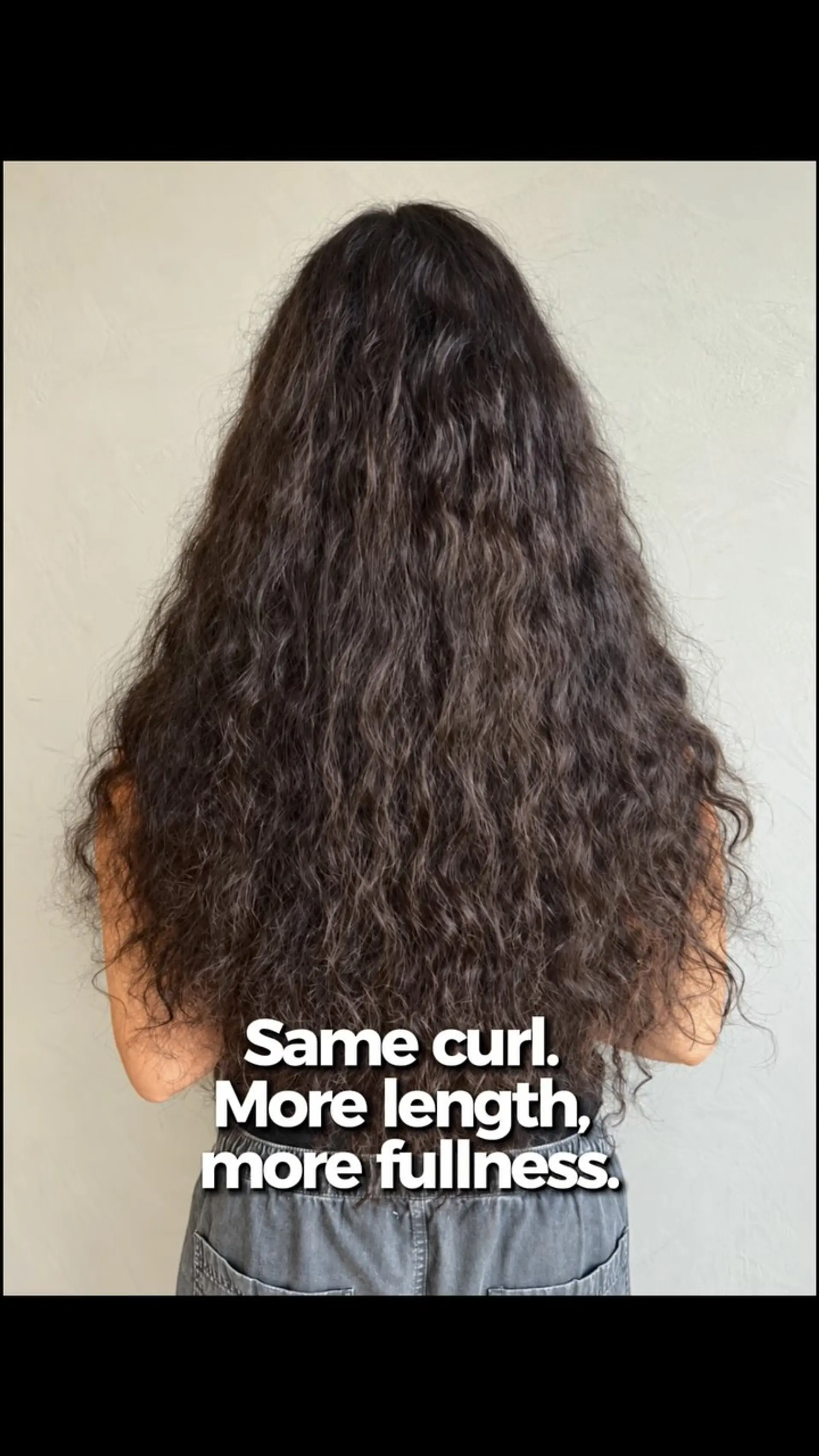 Extra long, voluminous dark curly hair enhanced with seamless extensions. 1
