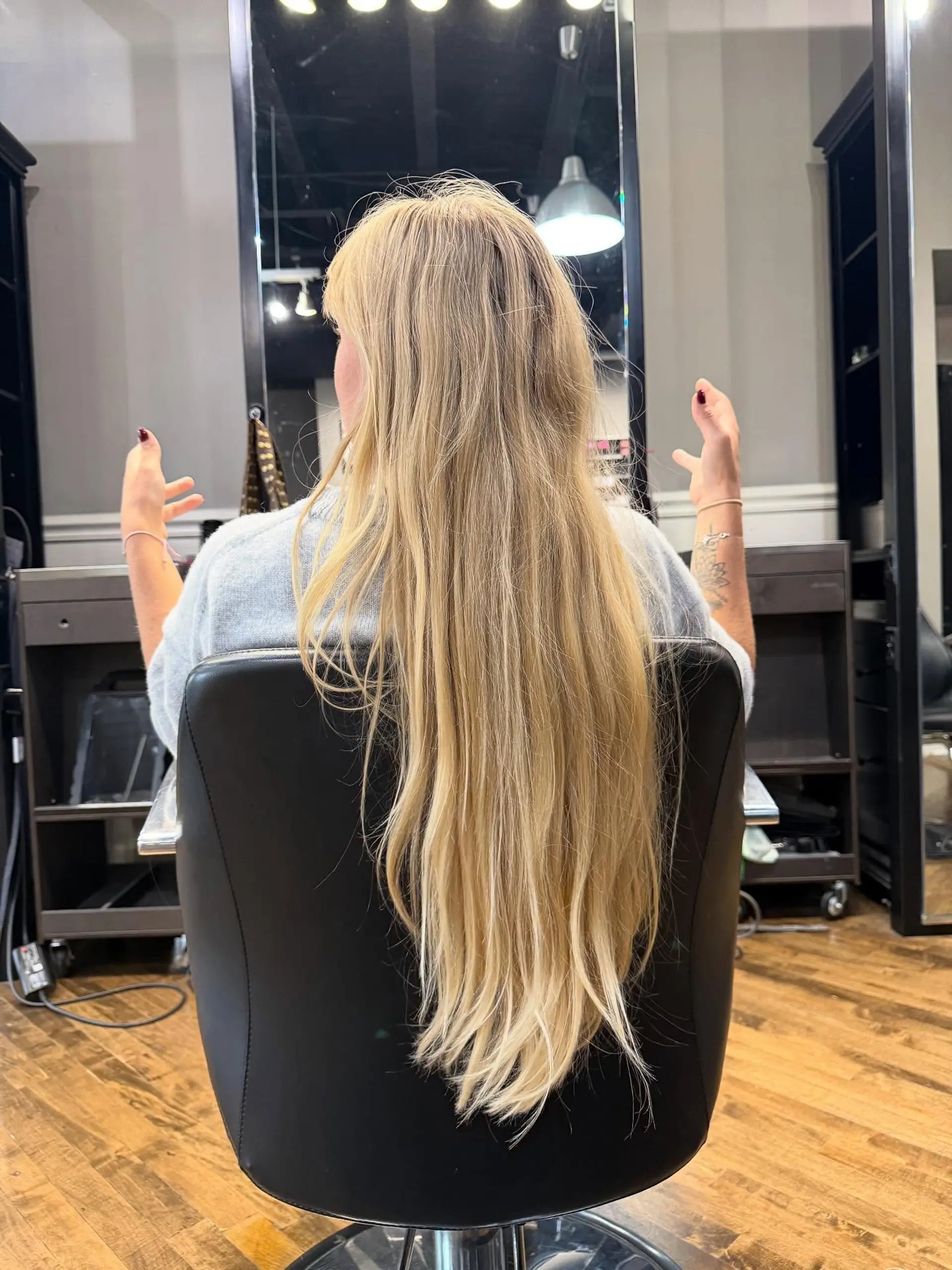 Extra long, warm natural blonde hair falling straight down past the styling chair. 1