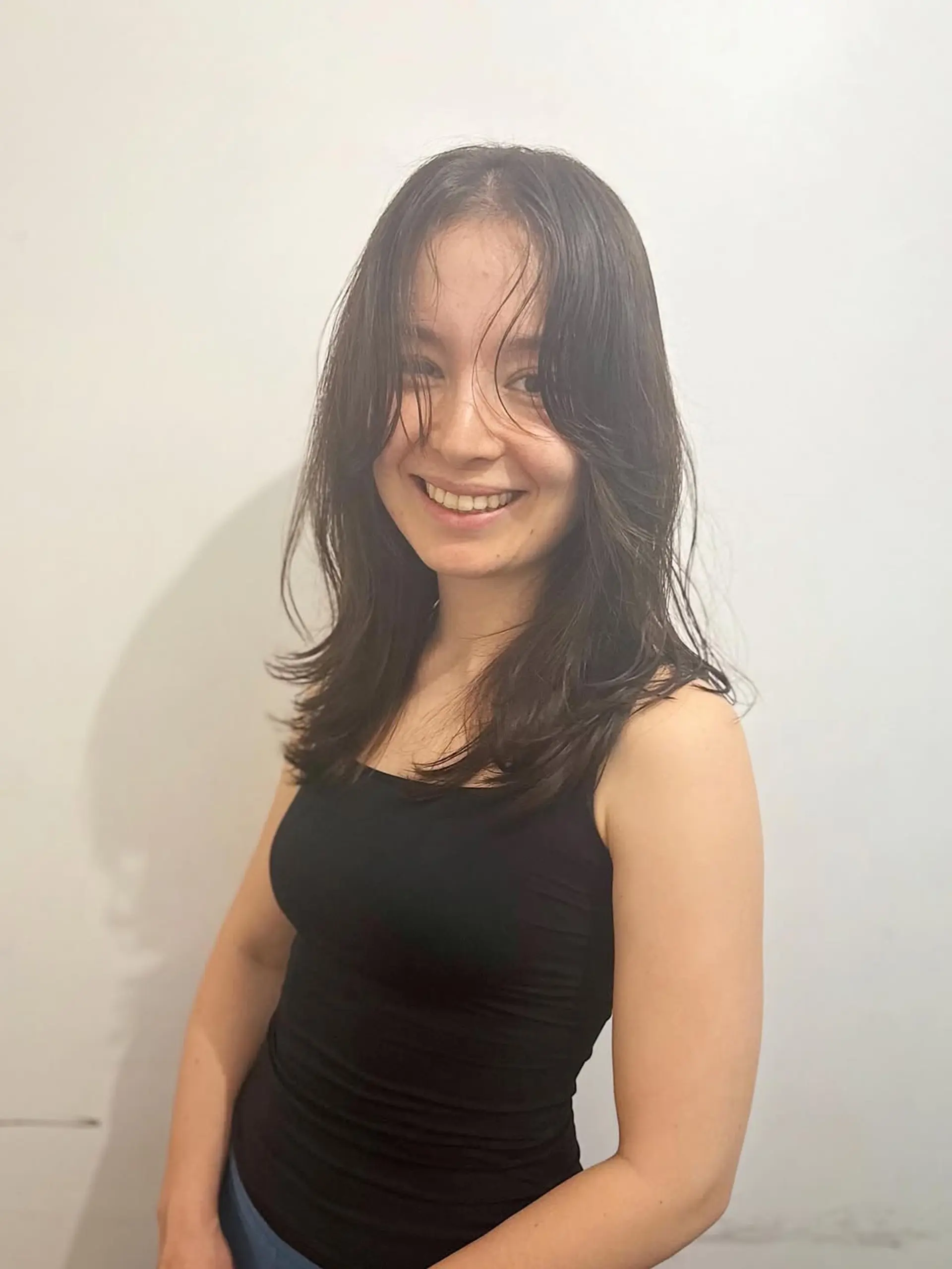 A medium-length layered shag cut with soft, face-framing layers that create movement and volume, giving an effortlessly chic and natural appearance. 1