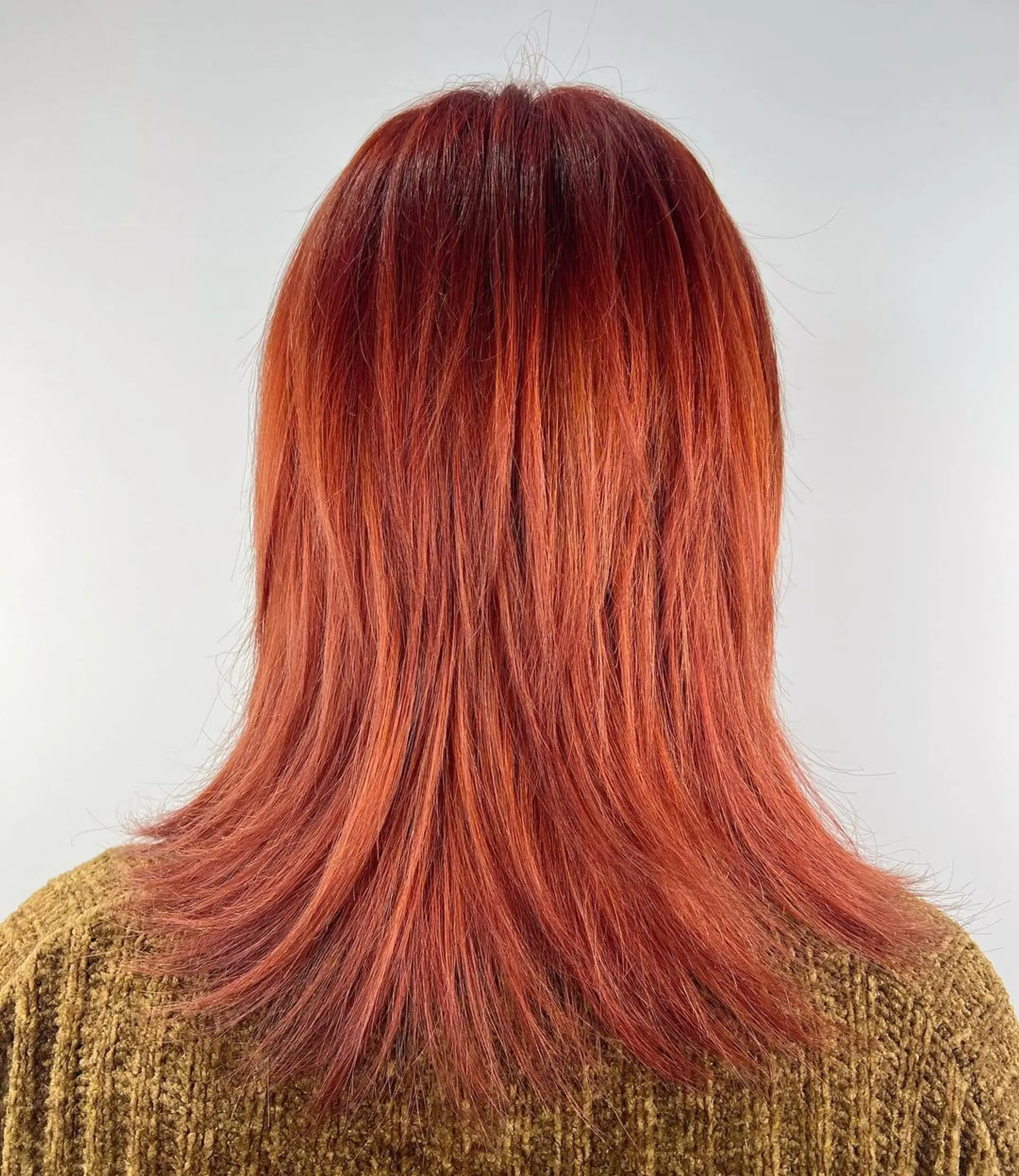 Straight, shoulder-length hair in a rich red hue, styled with blunt bangs and layered throughout for added texture and movement. 2