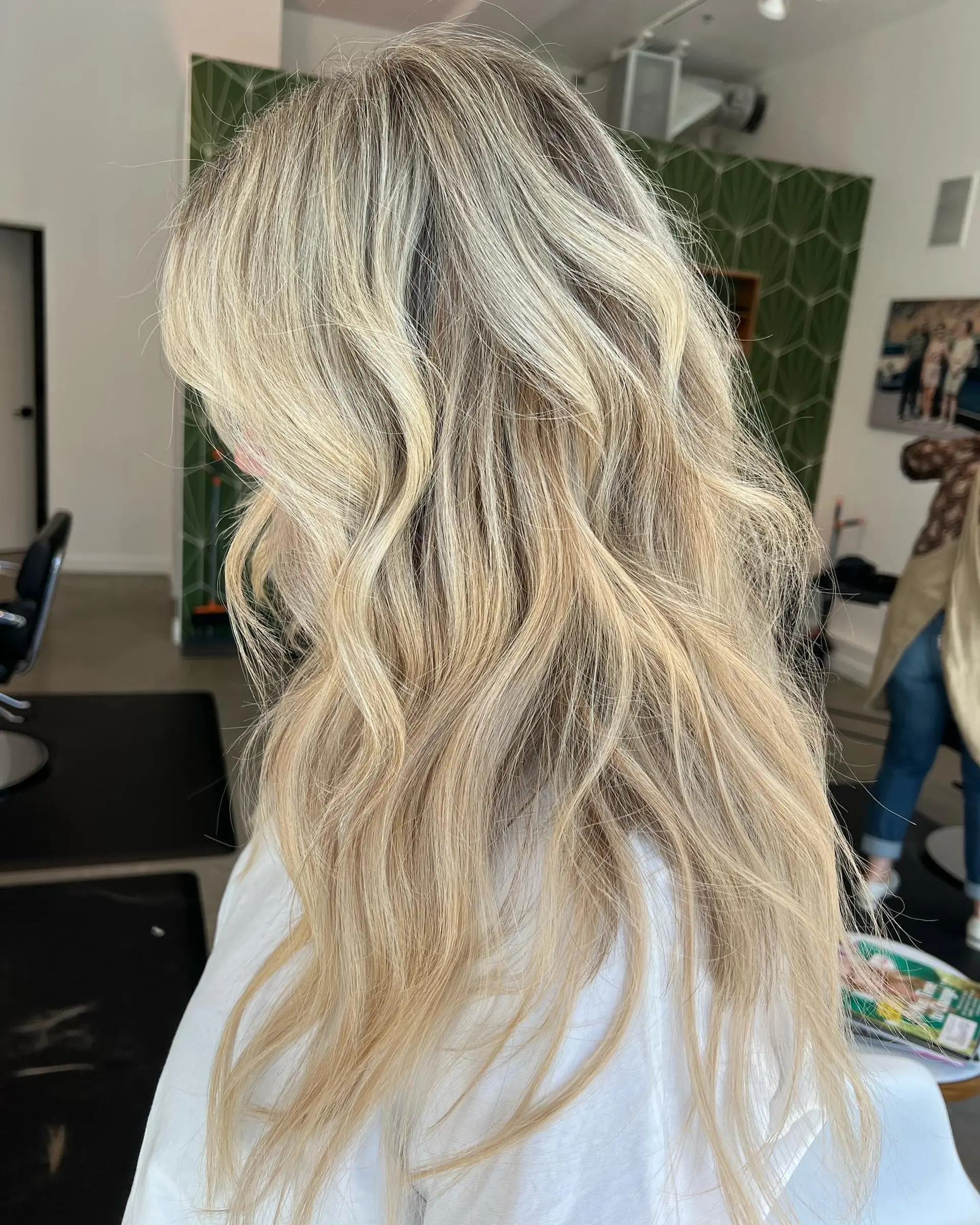 Long dimensional blonde hair styled in soft, textured waves. 1