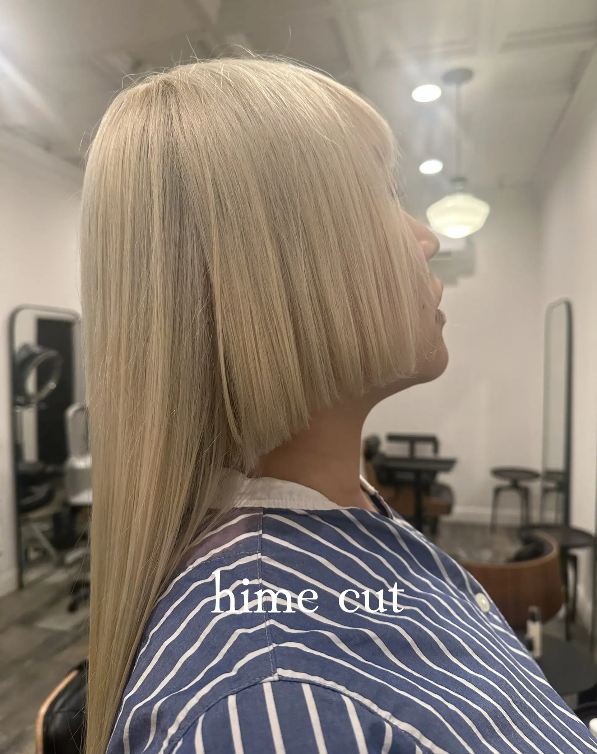 A sleek platinum blonde hime cut featuring sharp, blunt jaw-length side panels paired with long, straight back lengths. 1