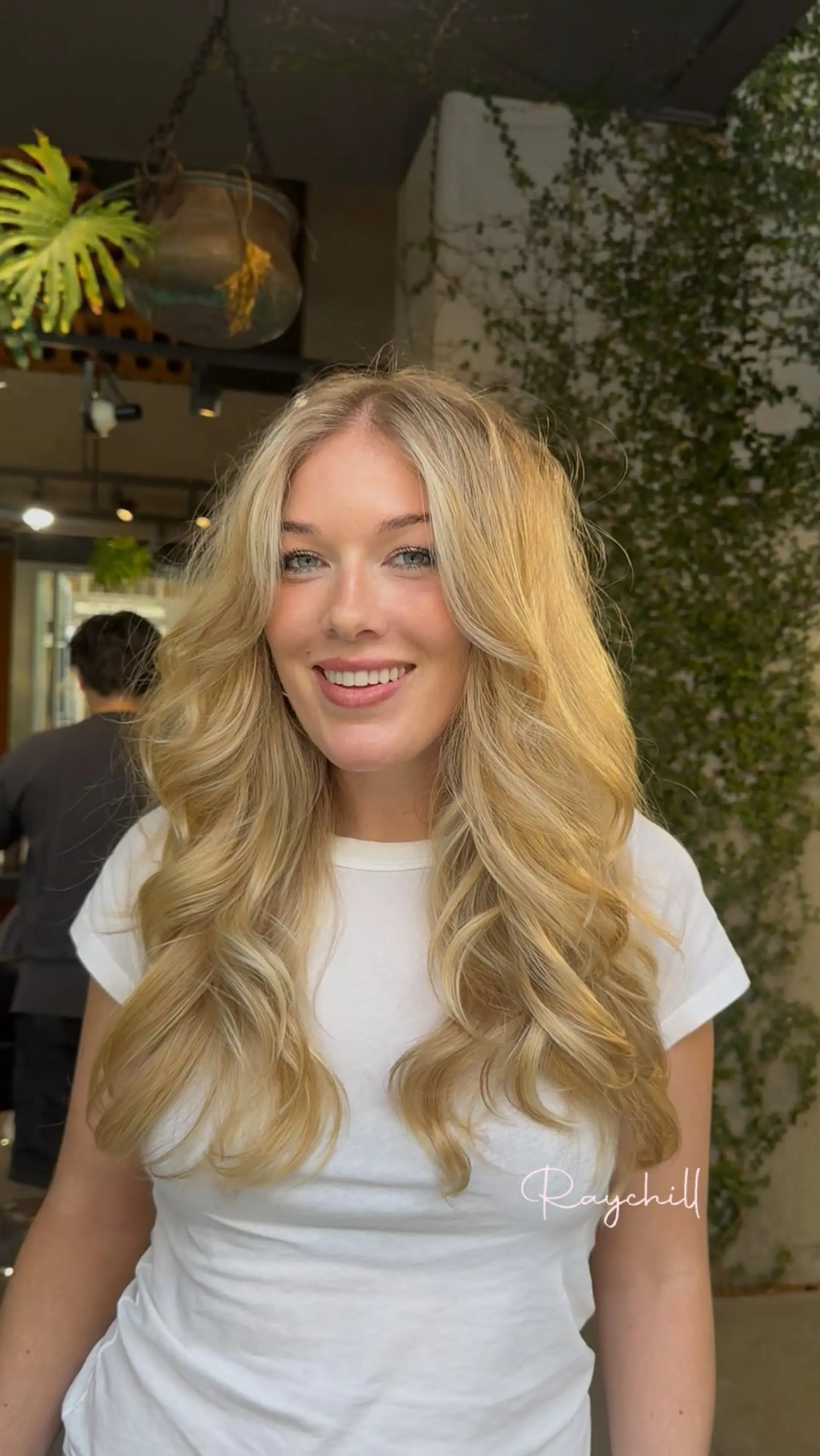 Long warm blonde hair styled in a bouncy, voluminous blowout with soft face-framing layers. 1