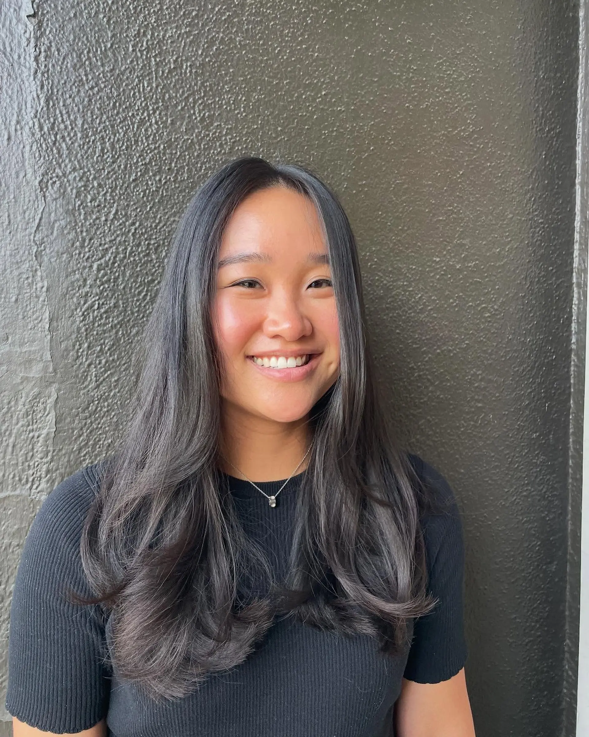 Long layered hair with soft waves. 1