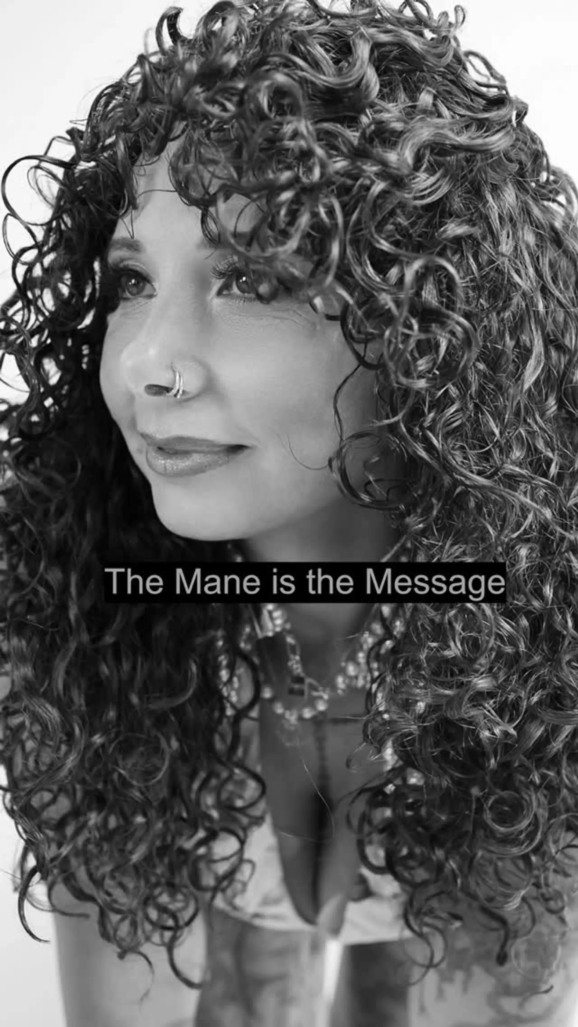 Full, voluminous natural curls styled with textured curly bangs framing the face. 1