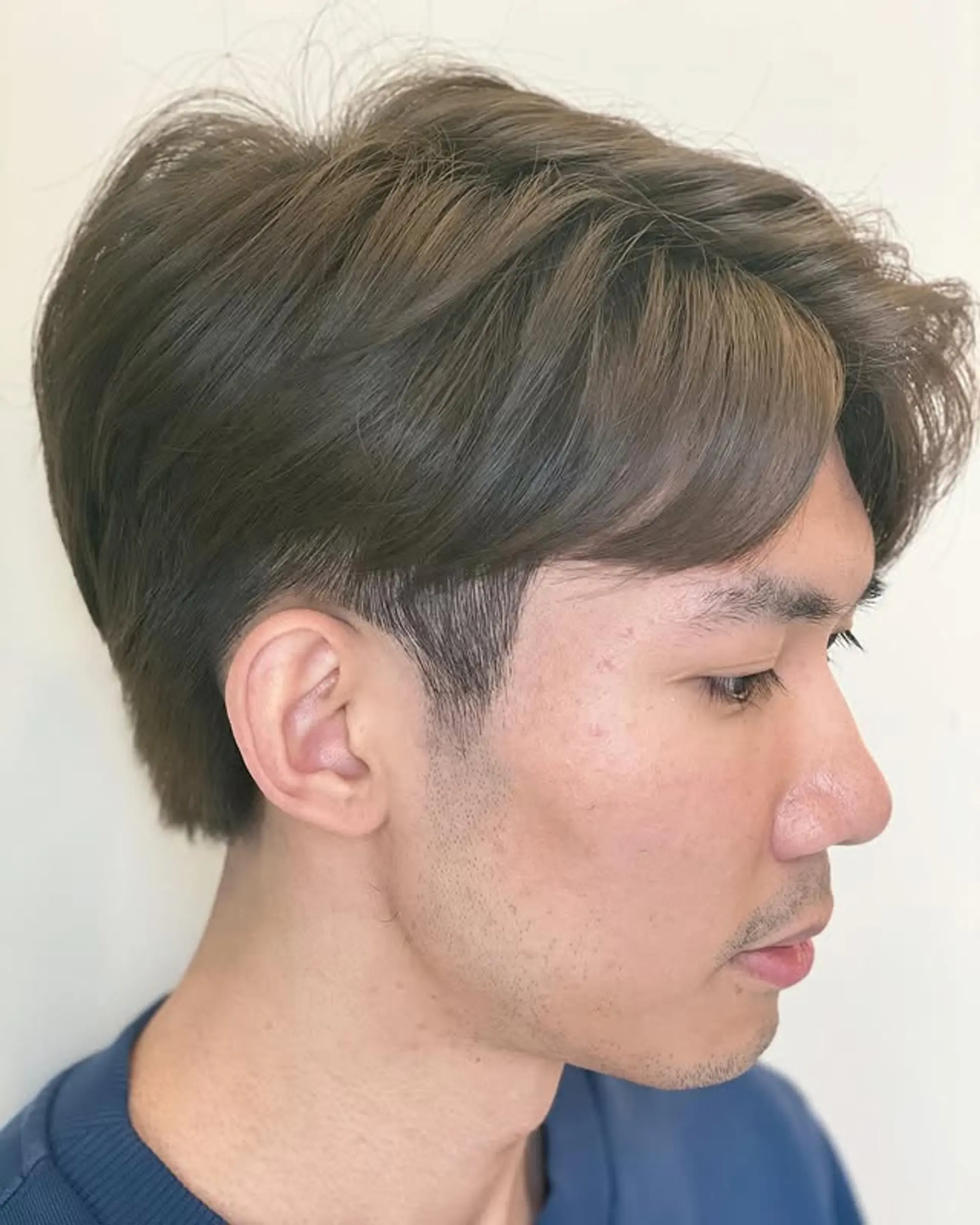 A modern side swept hairstyle with tapered sides and added texture. 1