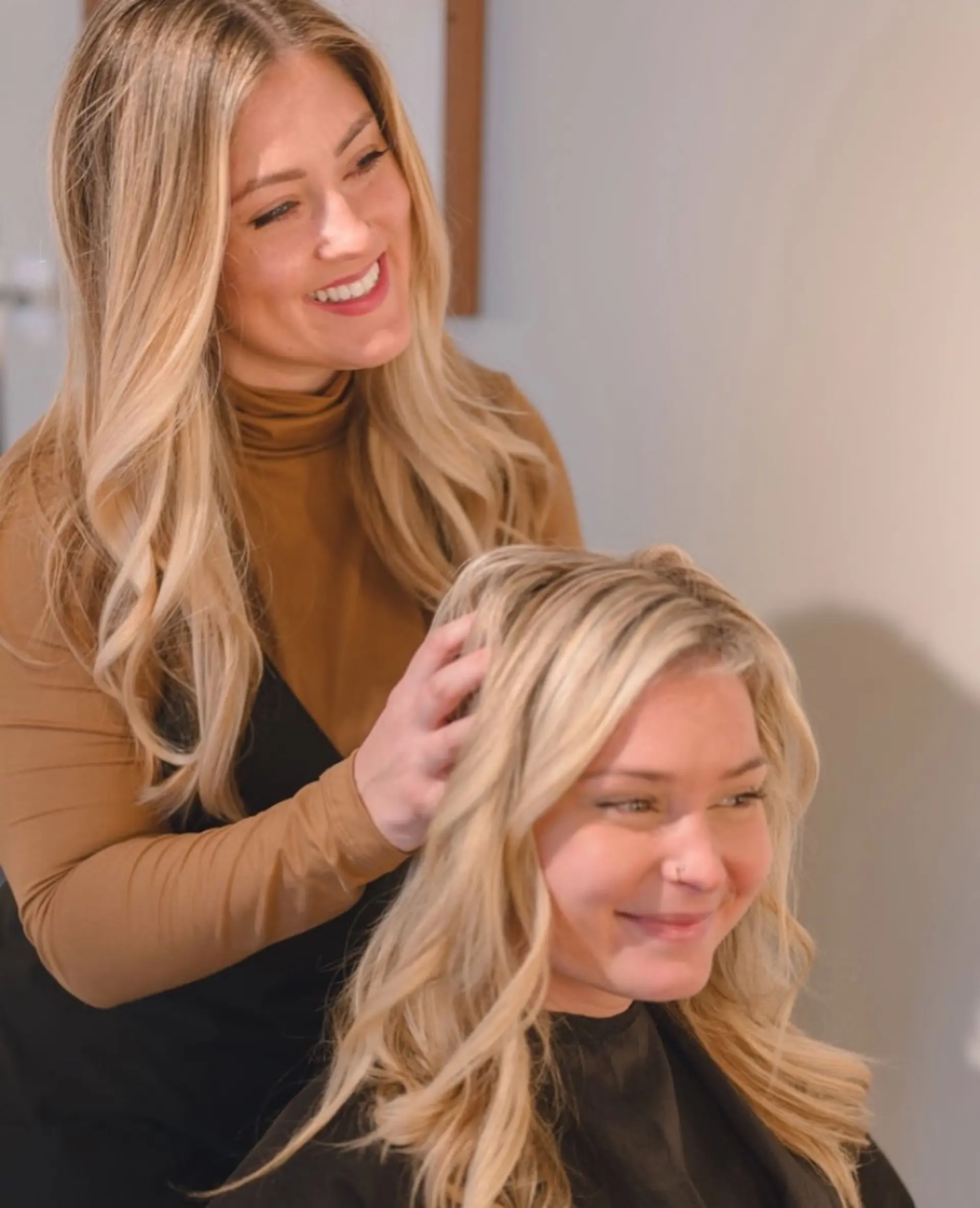 Warm golden-blonde hair styled in loose, soft waves with seamless dimension and volume. 1