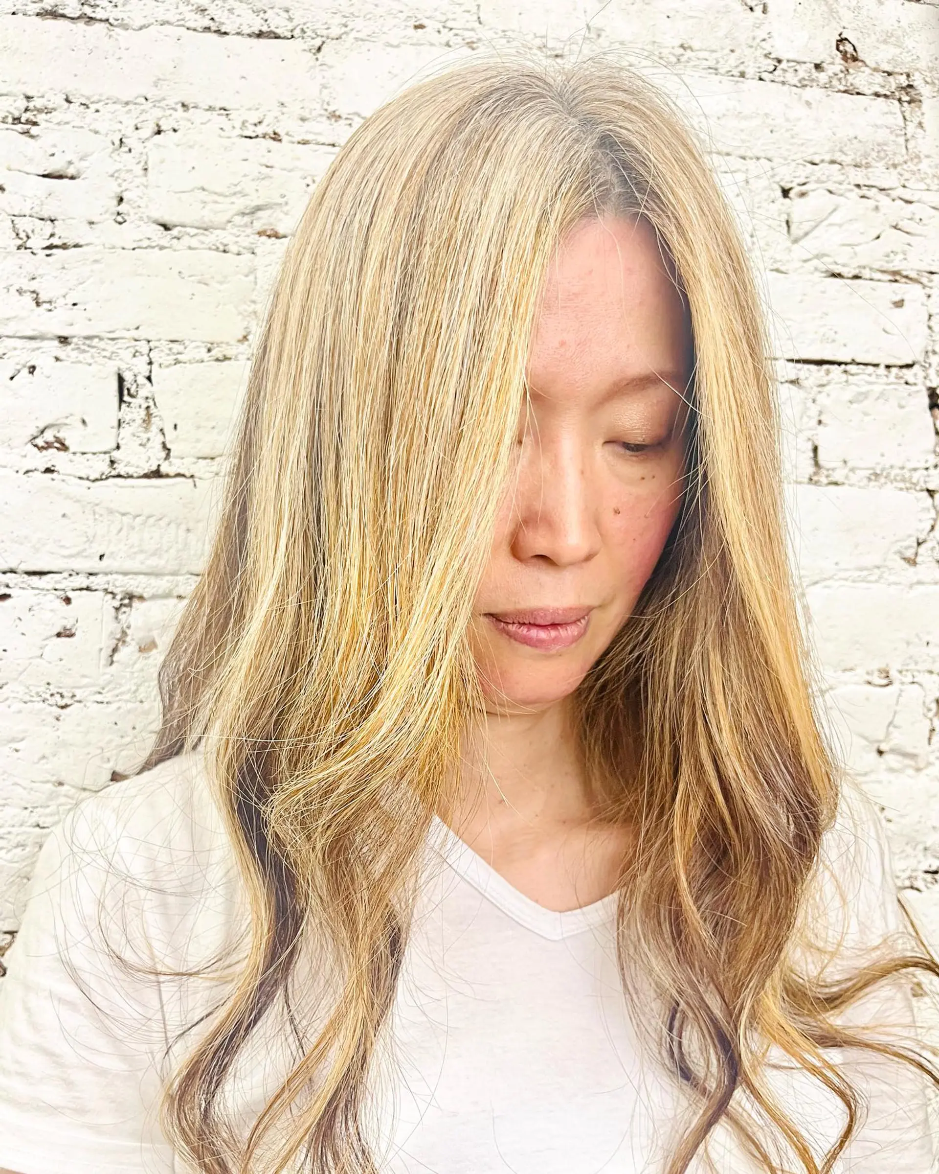 Long multi-dimensional blonde highlighted hair with face-framing strands and soft waves. 1