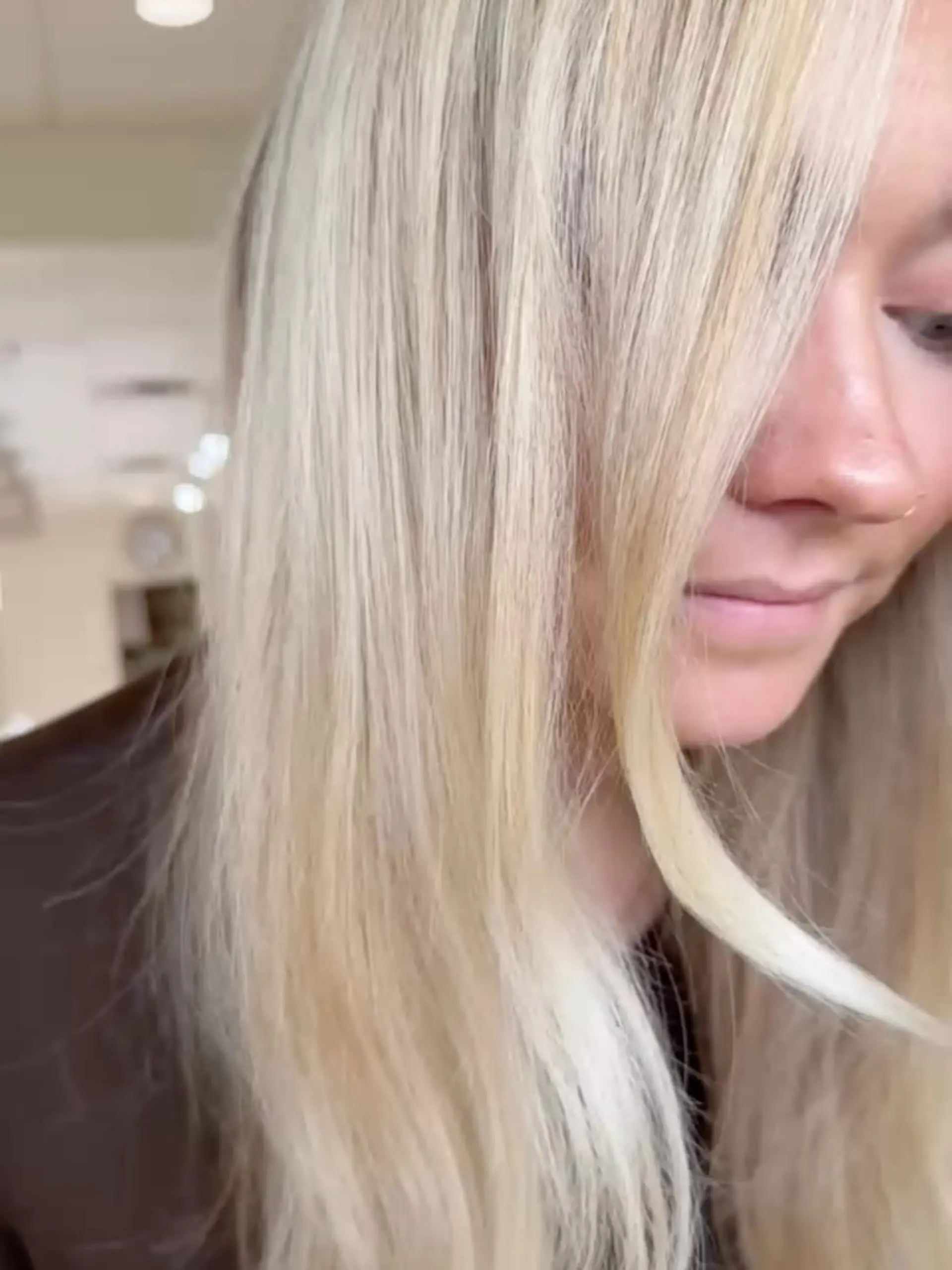 Long, bright platinum blonde hair styled smooth and straight around the face. 1