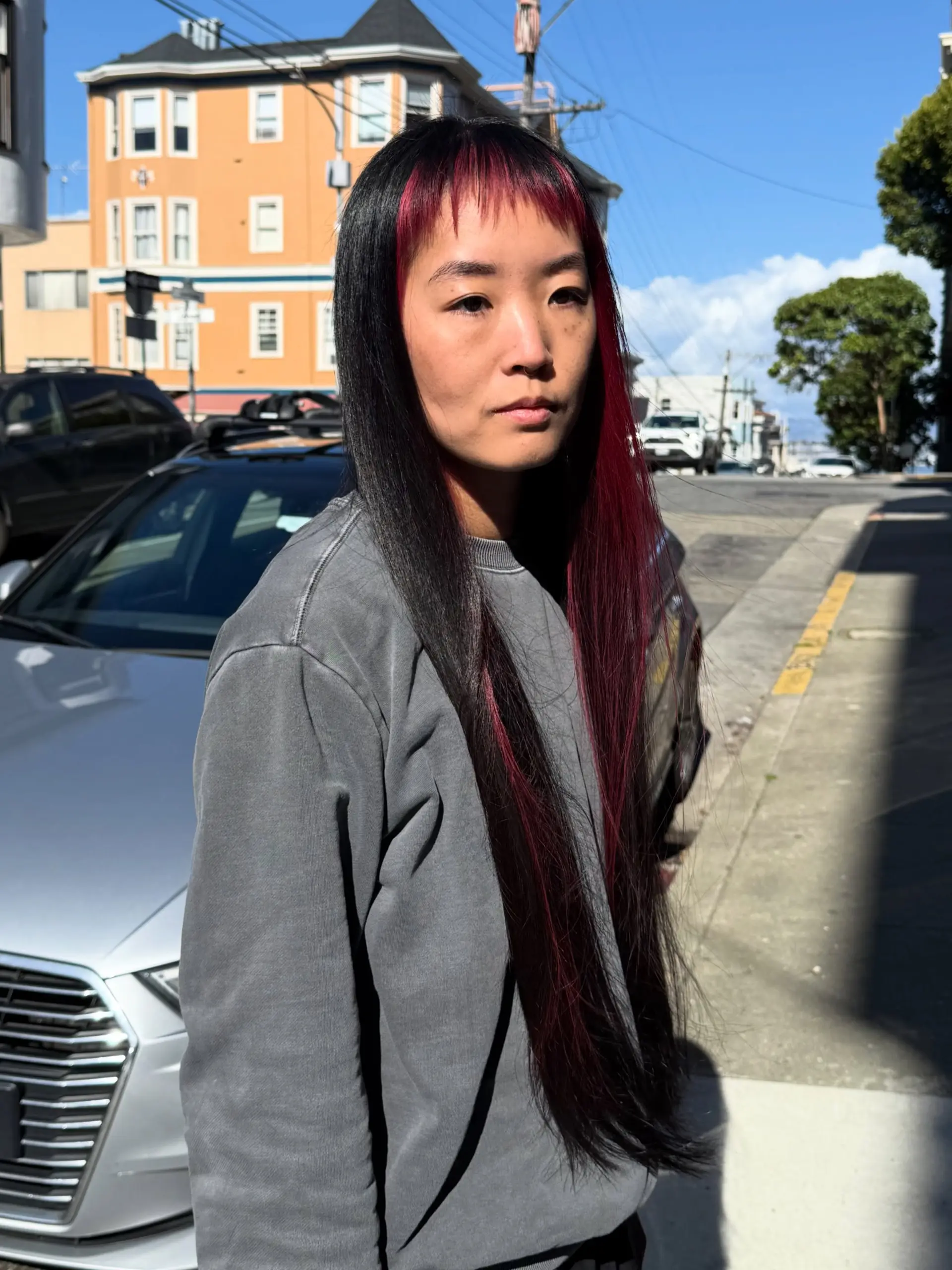 Extra long, sleek straight black hair with bold crimson red micro bangs and matching face-framing streaks. 1