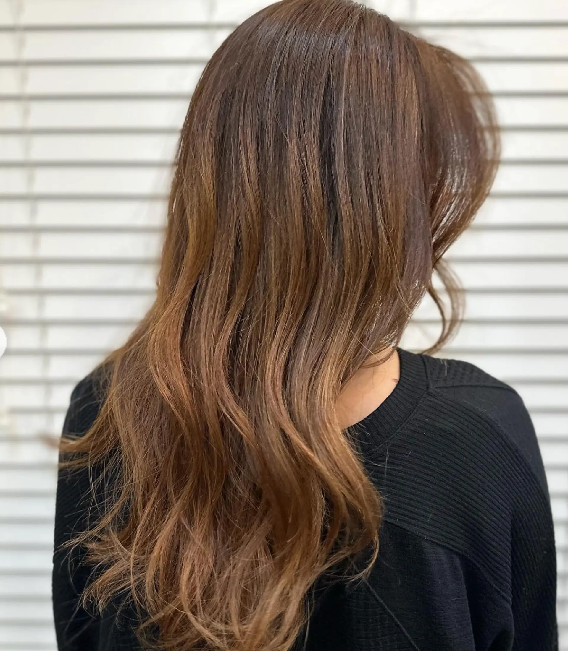 Long, light brown wavy hair with golden highlights, soft waves, face-framing layers, and a side part.

 2